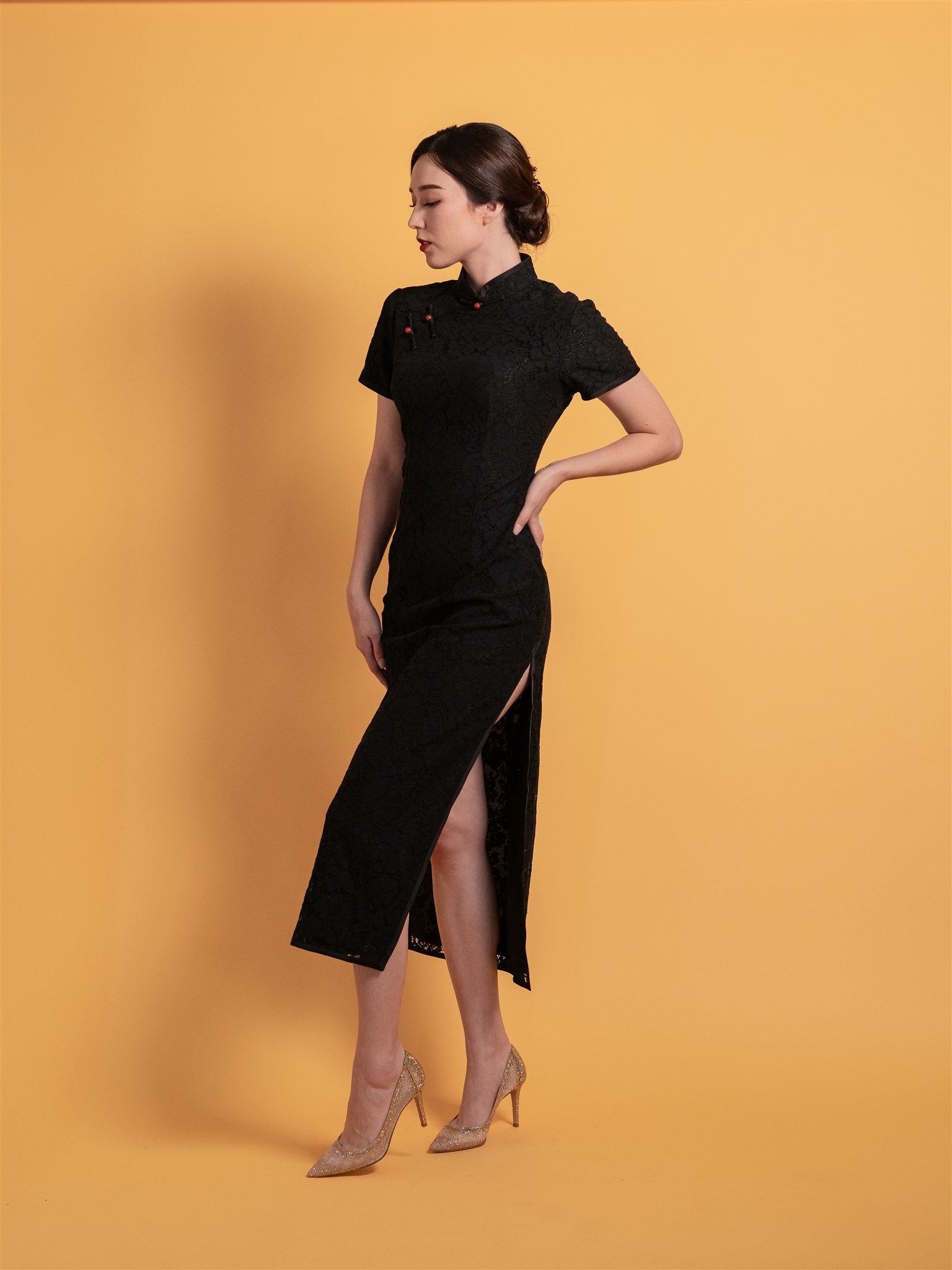 Side view of a black cotton lace Qipao with a mandarin collar, cap sleeves, and elegant frog knot button, ideal for casual daily wear.