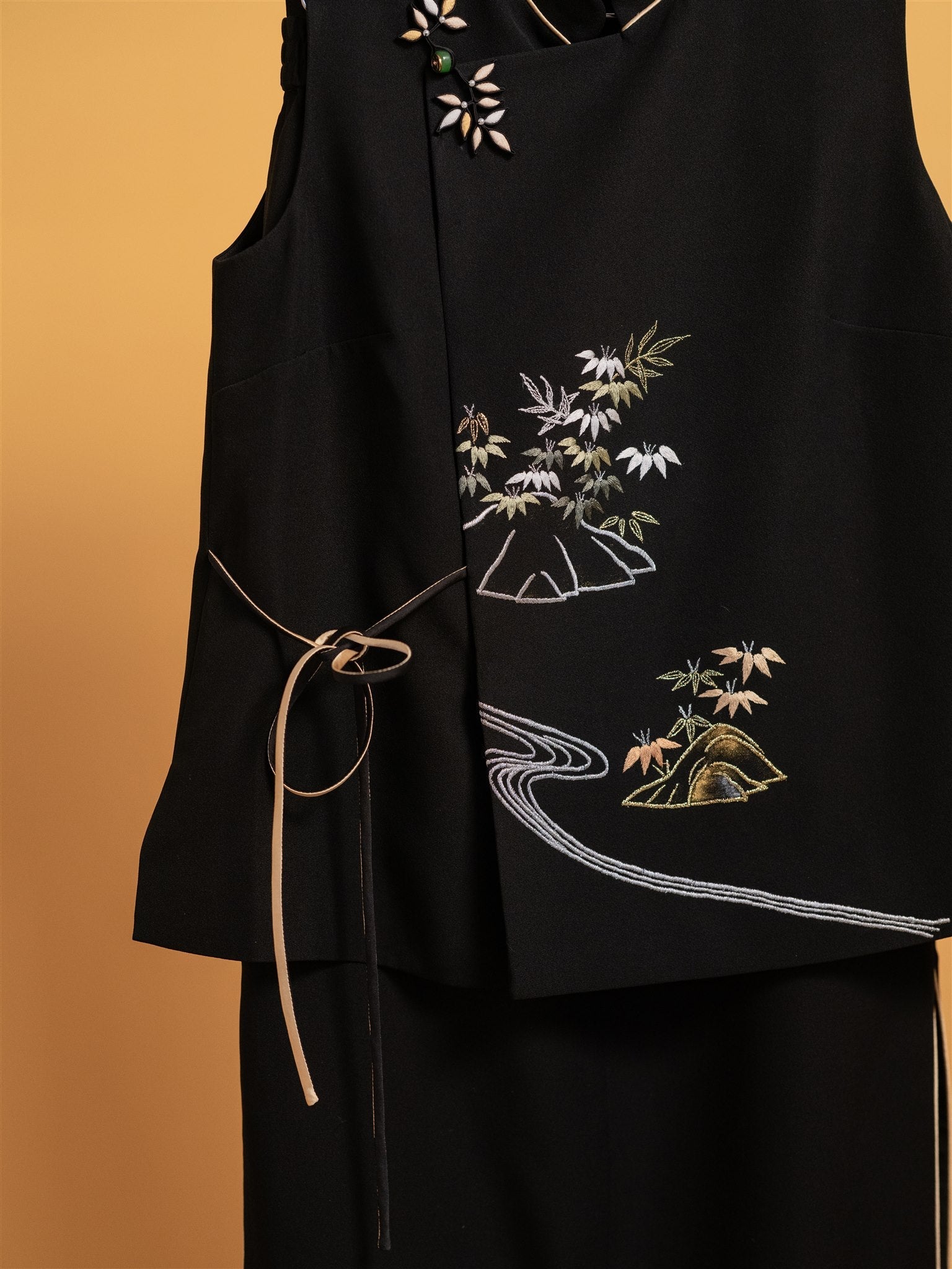 Close-up detail of the bamboo hand embroidery on a black Japanese silk 2-piece set, designed for an elegant and comfortable daily look.