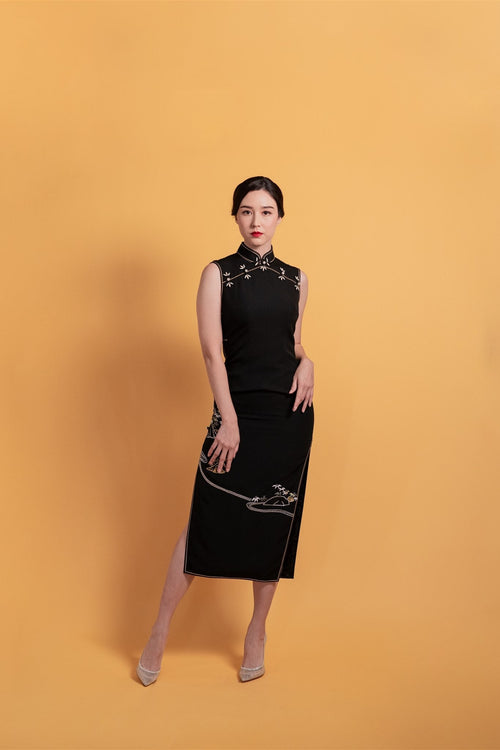 Black Japanese silk Cheongsam with gold mountain embroidery, front view.