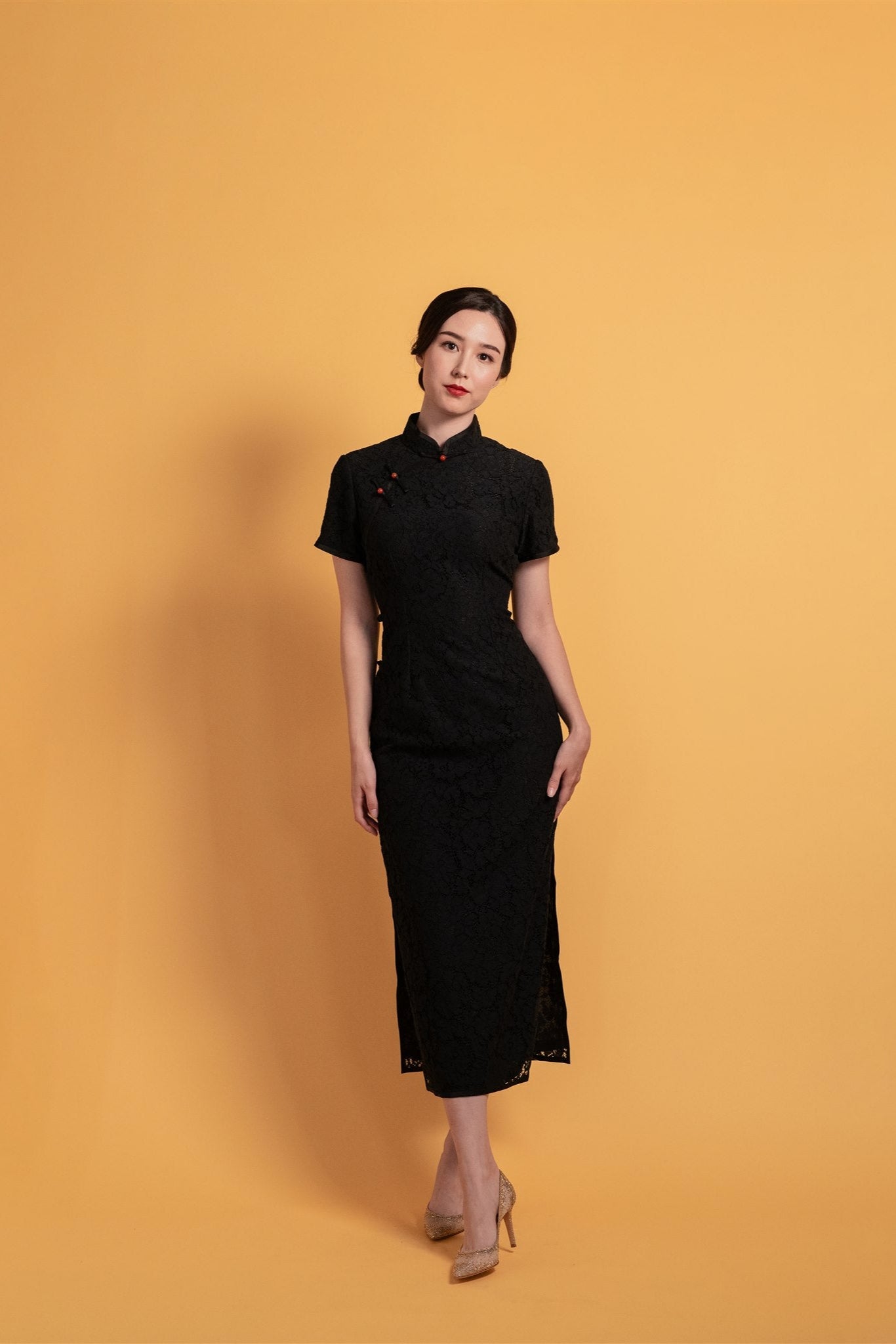 Black lace Cheongsam with cap sleeves and red Pankou closure, front view.