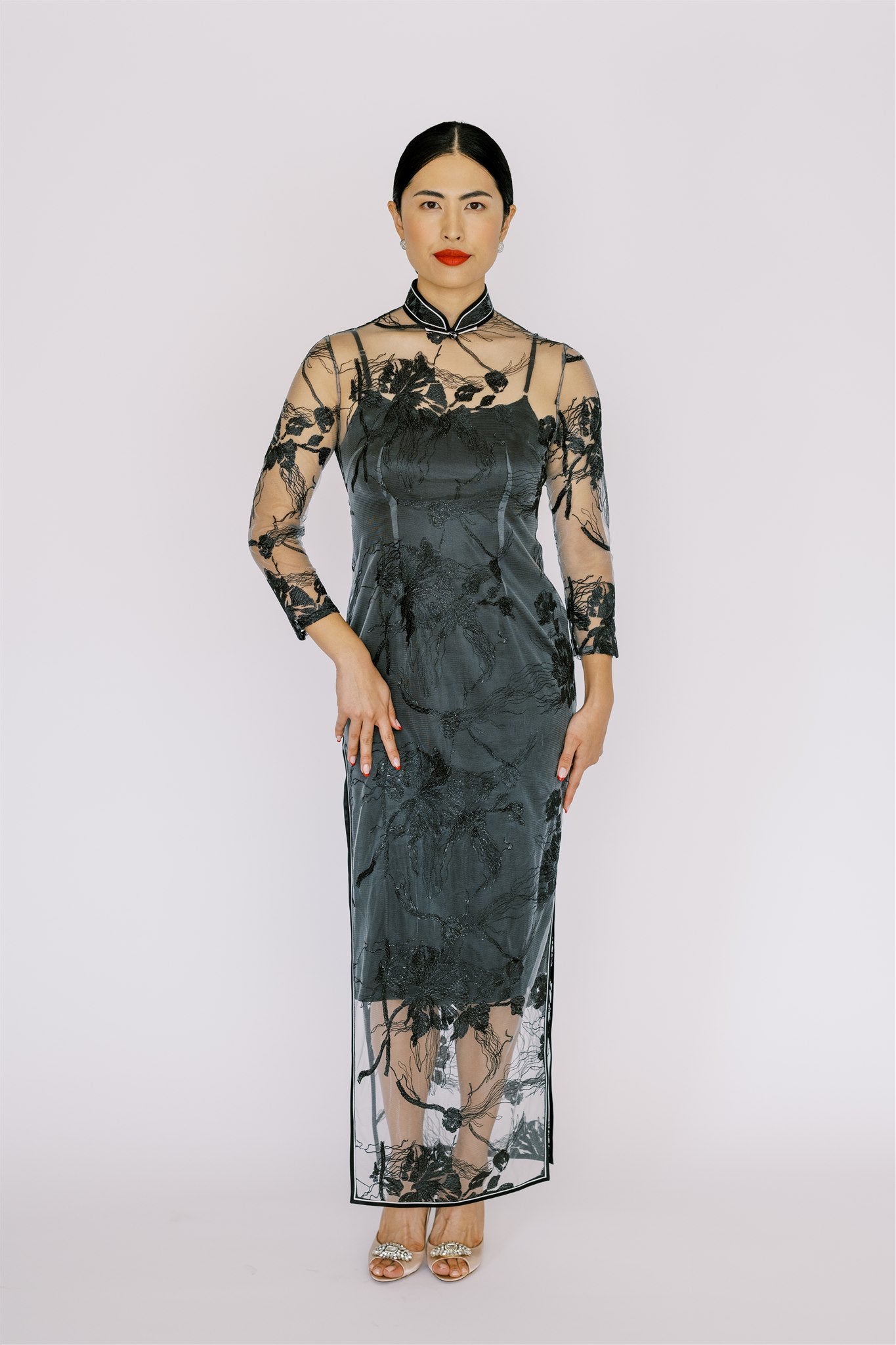 A woman is wearing a modern Floral Lace Qipao with Silk Slip Dress, Long Sleeves