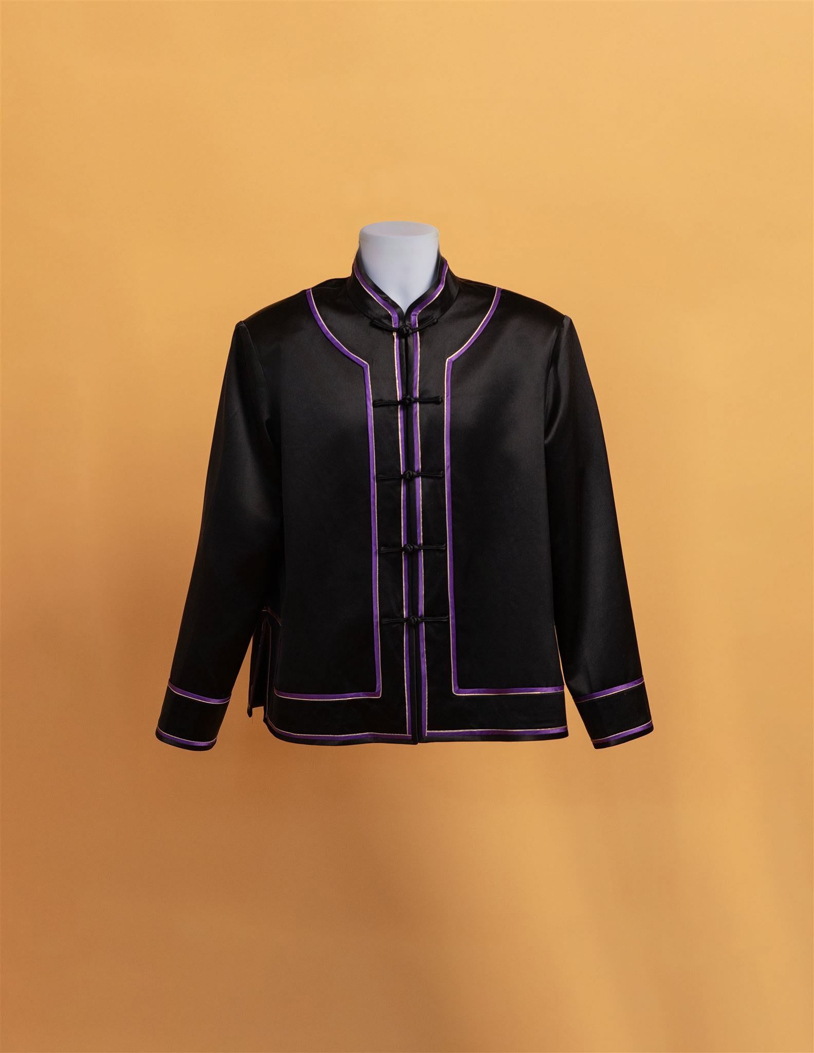 Front view of a black silk tang suit for men with purple piping. 