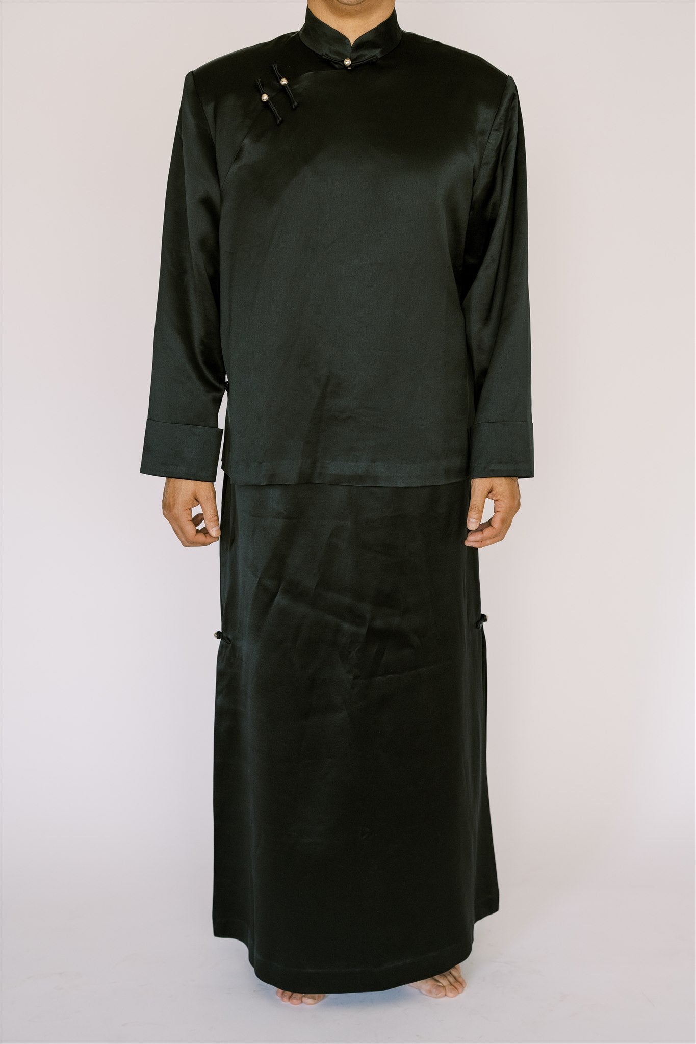 A man wearing black silk tang suit with skirt