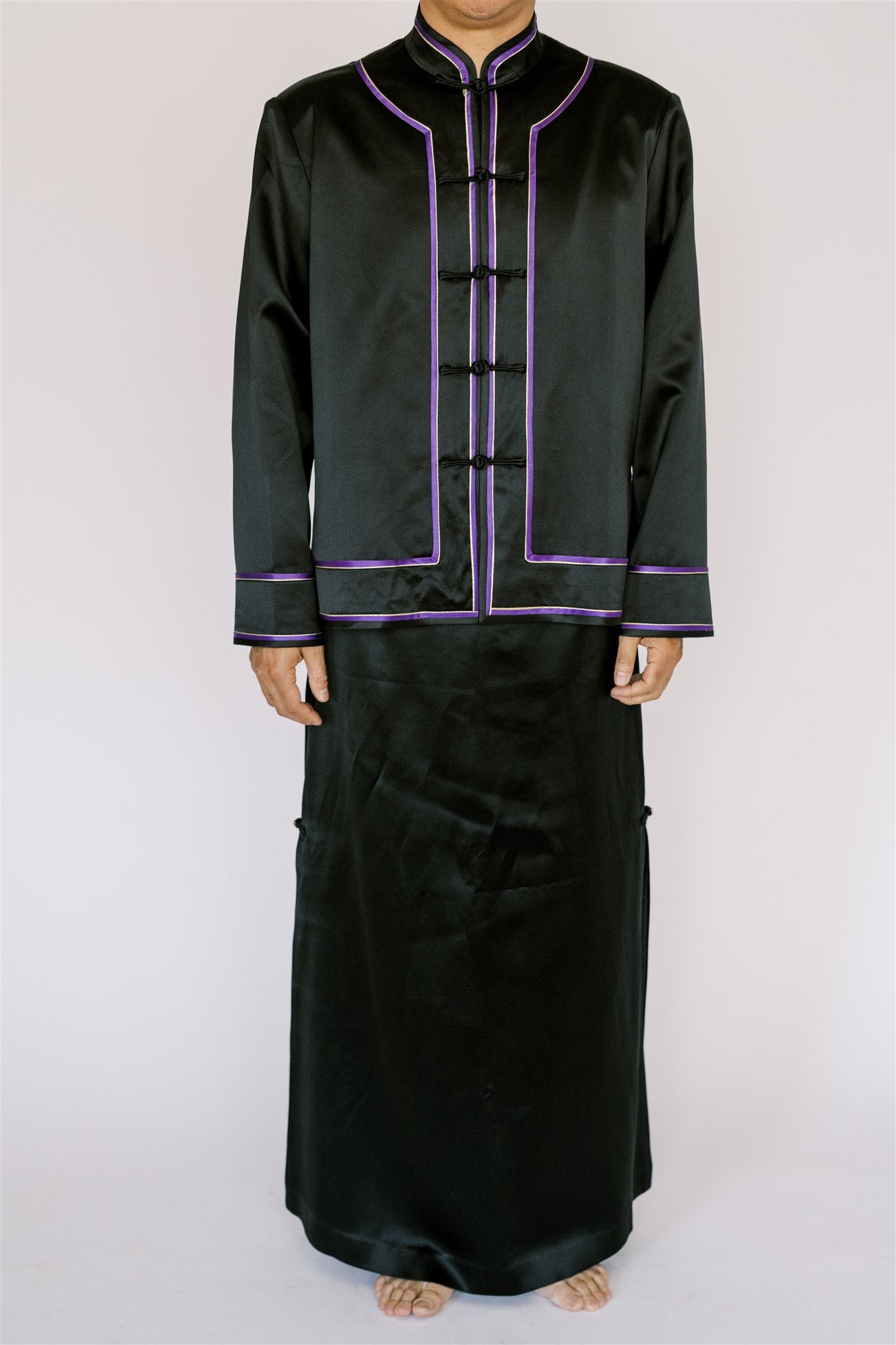 A man wearing a black tang suit with purple trim