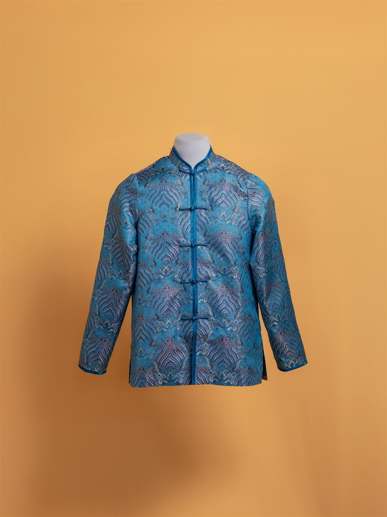 Front view of a blue silk brocade Tang suit jacket with traditional Chinese design, handcrafted by JINZA.