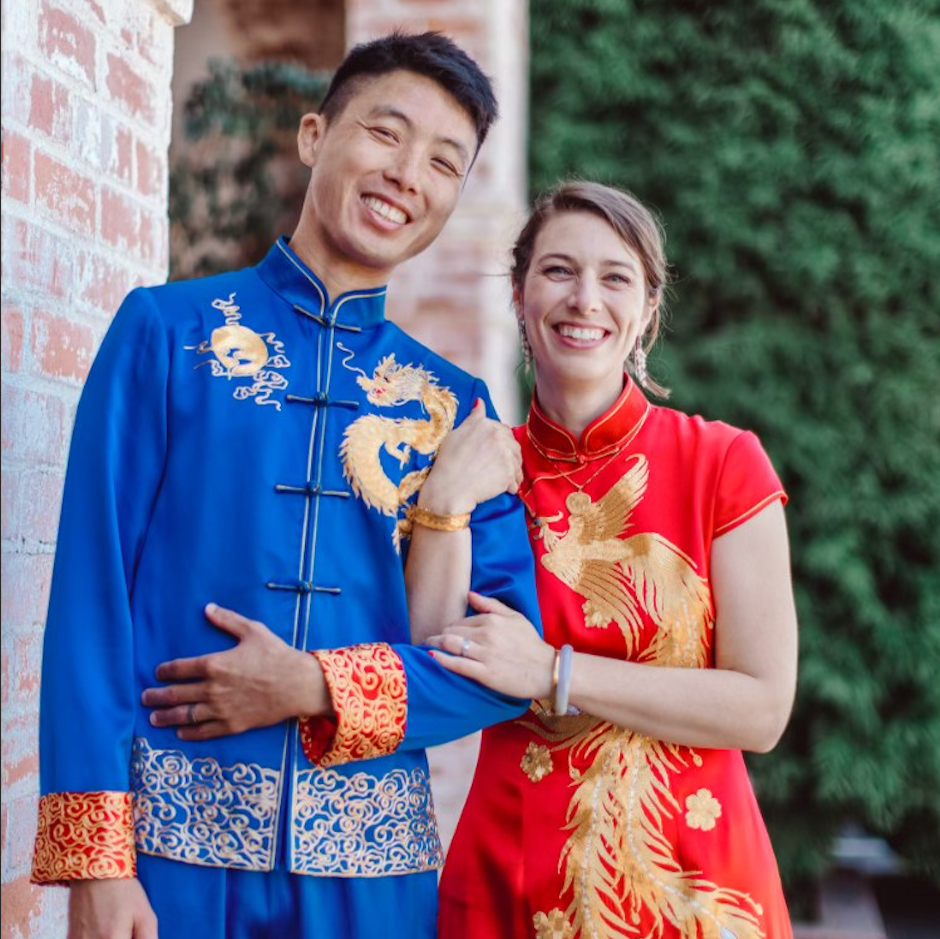 A couple is wearing matching tang suit and red chinese wedding dress