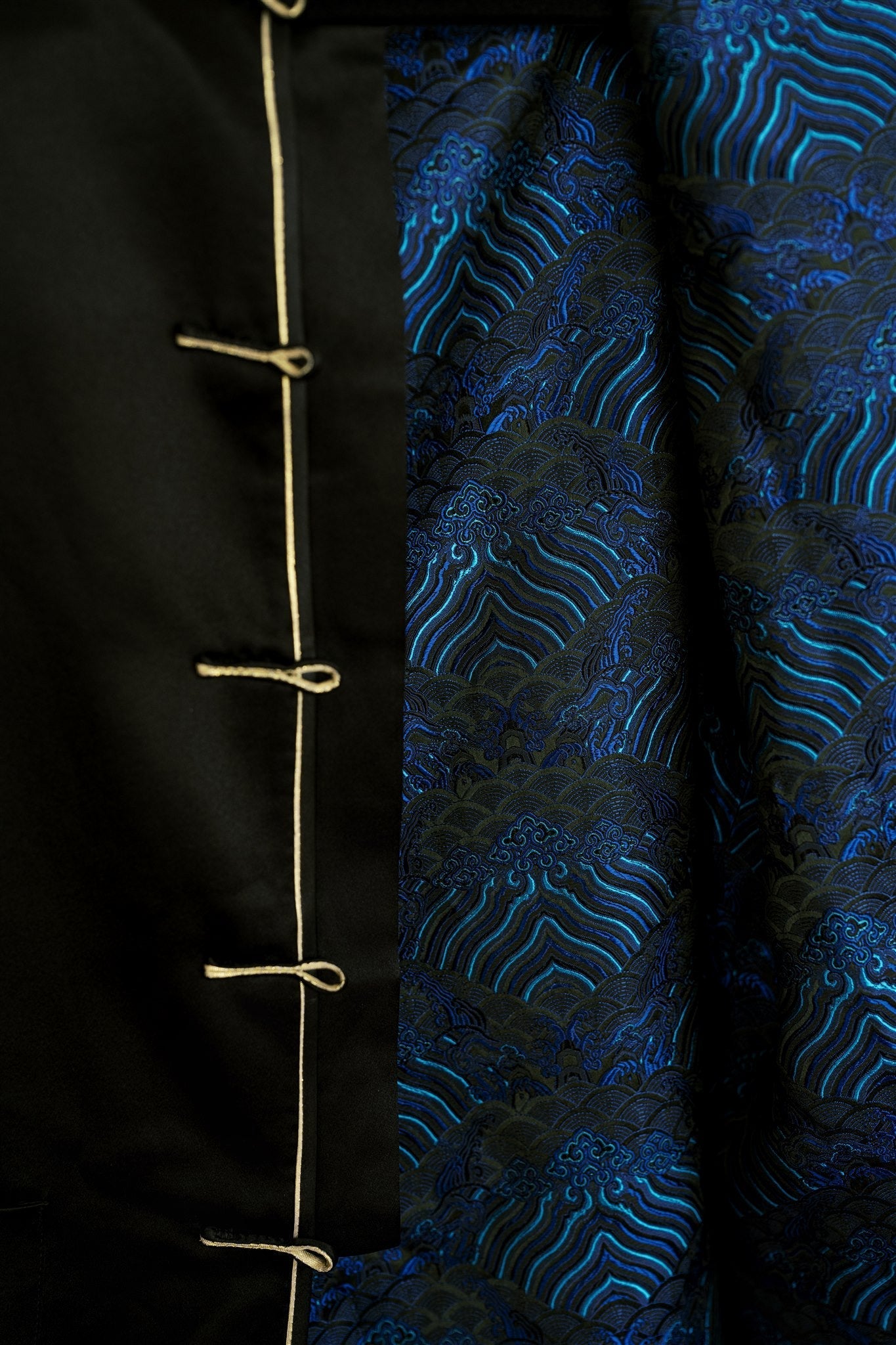 A silk black tang suit with blue strips silk lining