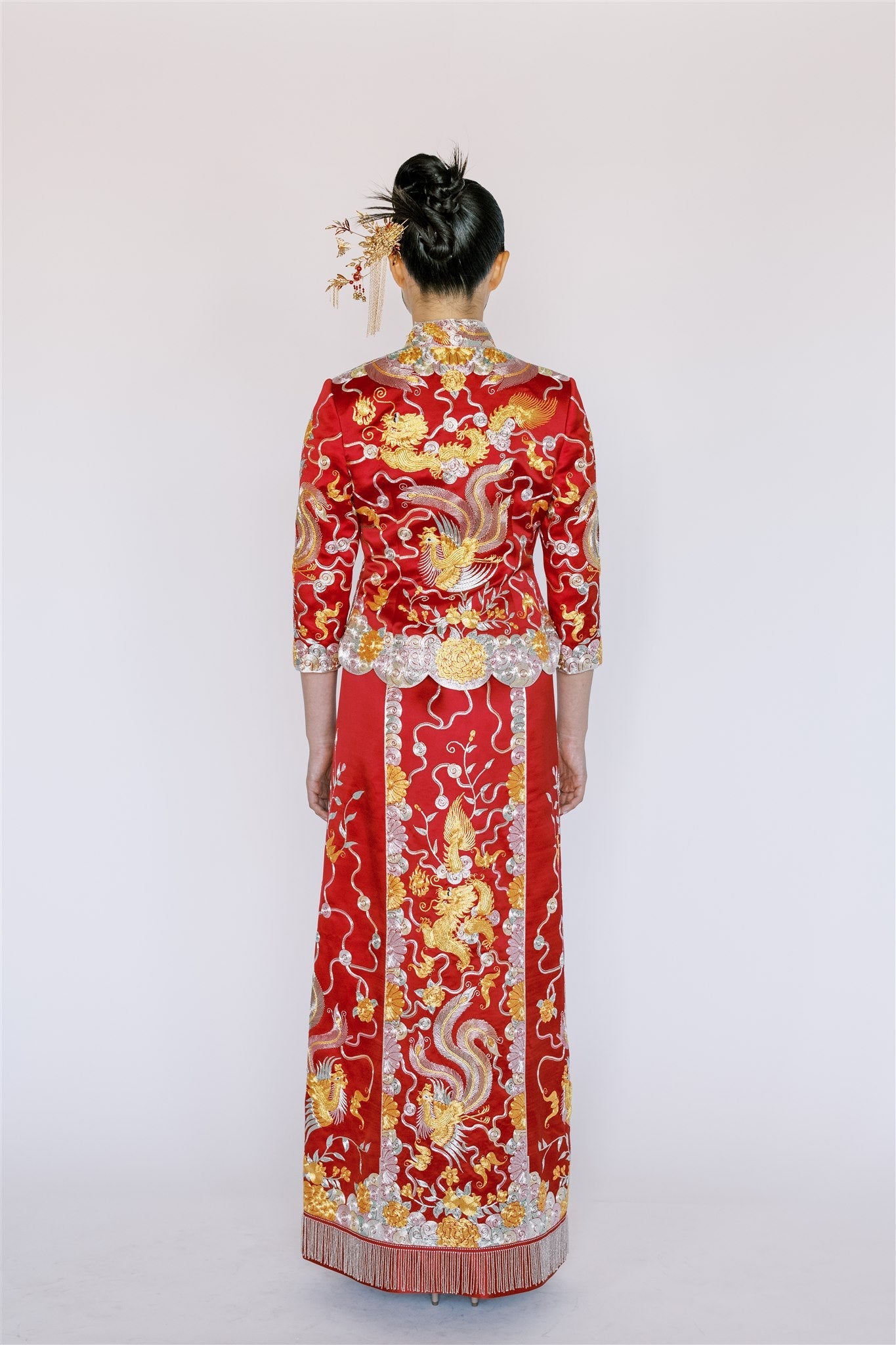 A red traditional Chinese Tea Ceremony Dress with gold, silver and green embroidery details