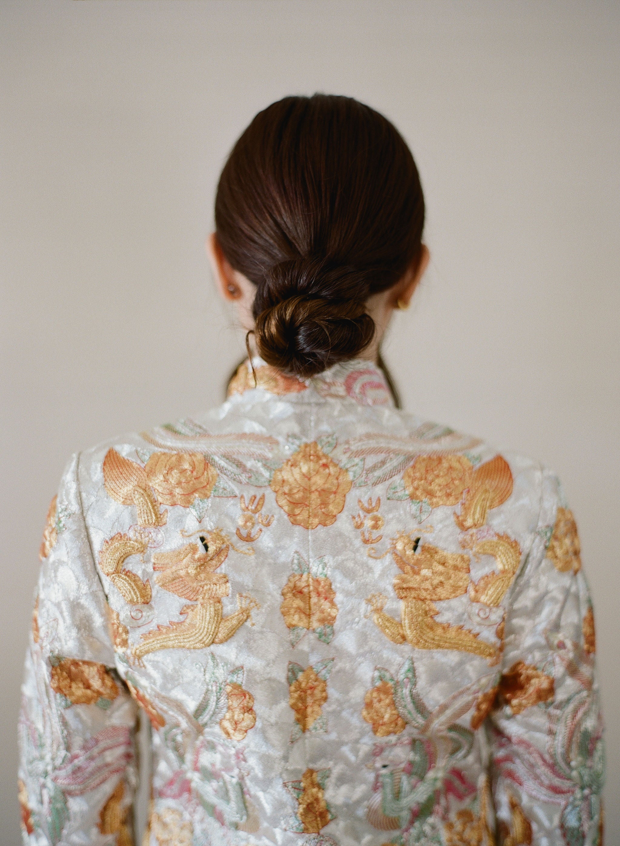 Back view of the detailed embroidery of dragon, peonies and phoenix embroidery on the Chinese Traditional Wedding Dress King Kwa look. 