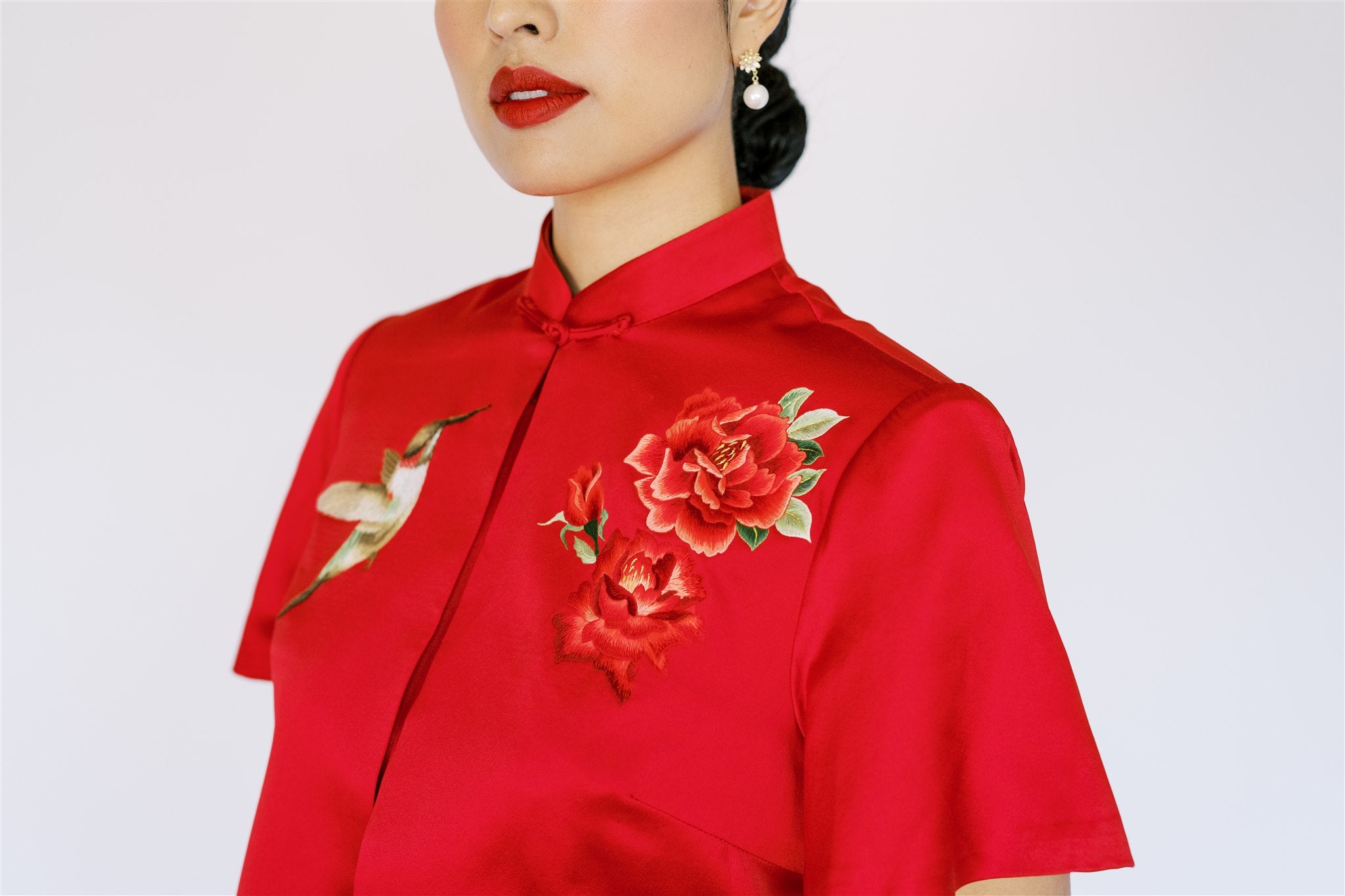 A red Chinese wedding dress jacket with a bird and roses hand embroidery