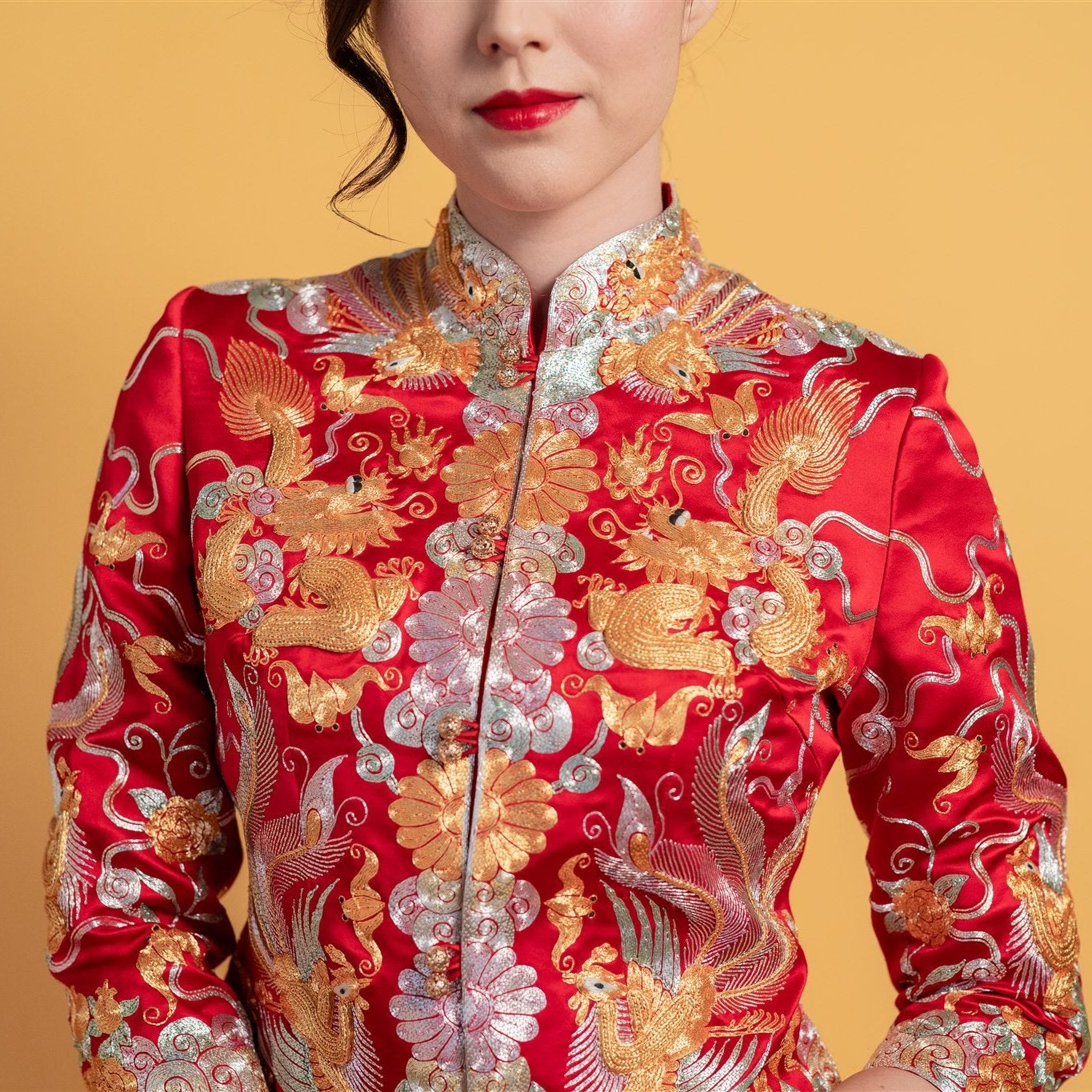 Close-up detail of the hand-embroidered dragon, phoenix, and peonies on the top of fitted Qun Kwa Xiao Wu Fu, our best-seller tea ceremony dress.