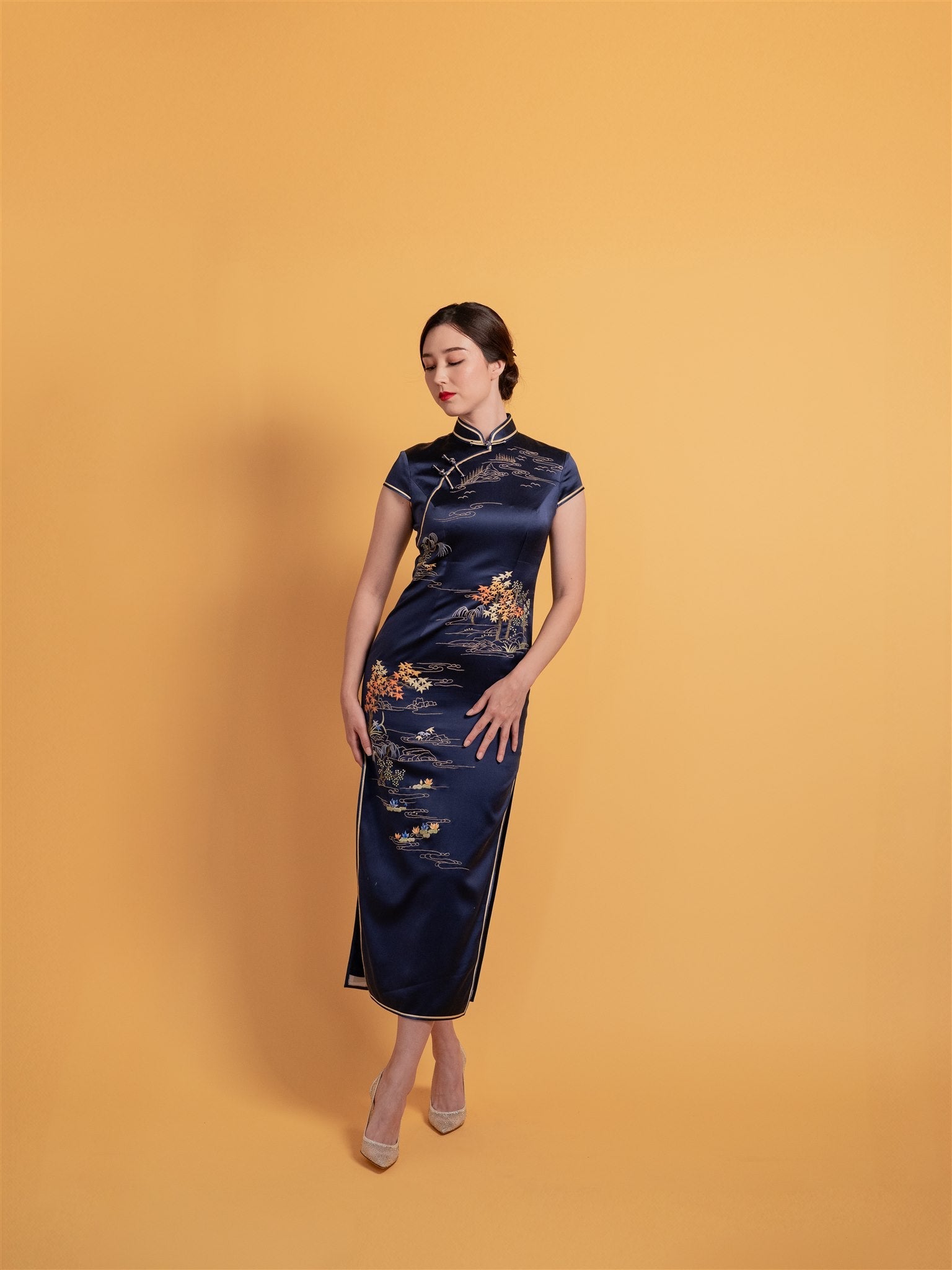 Front view of the embroidered Chinese wedding Qipao "Poet on the Mountain Top", a classic Chinese wedding dress with intricate landscape hand embroidery and cap sleeves.