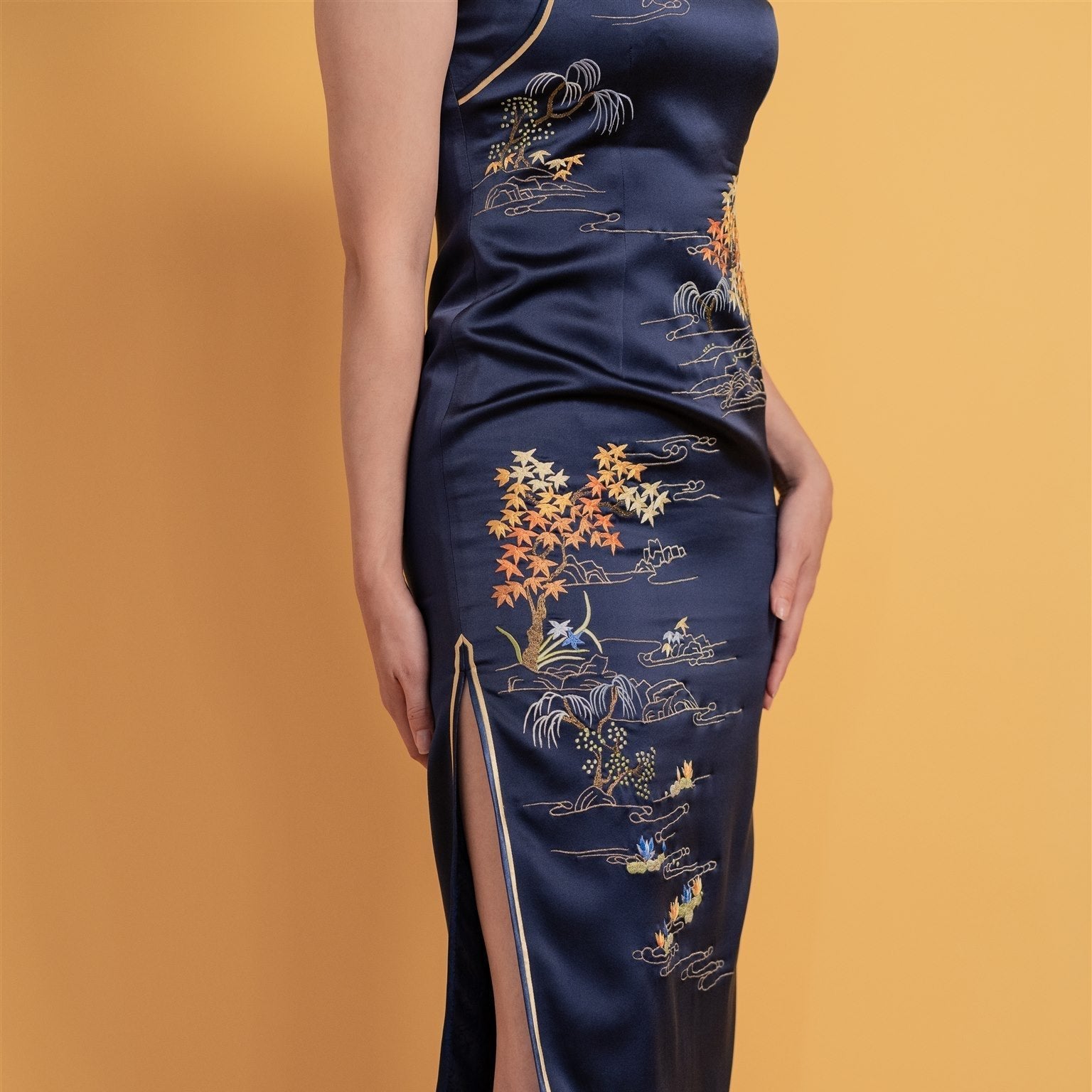 Close-up detail of classic water painting embroidery on Qipao, the intricate hand-stitched details on a traditional Chinese dress.