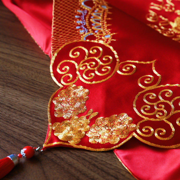 A close-up of a chinese wedding veil peonies embroidery and floral edge. 