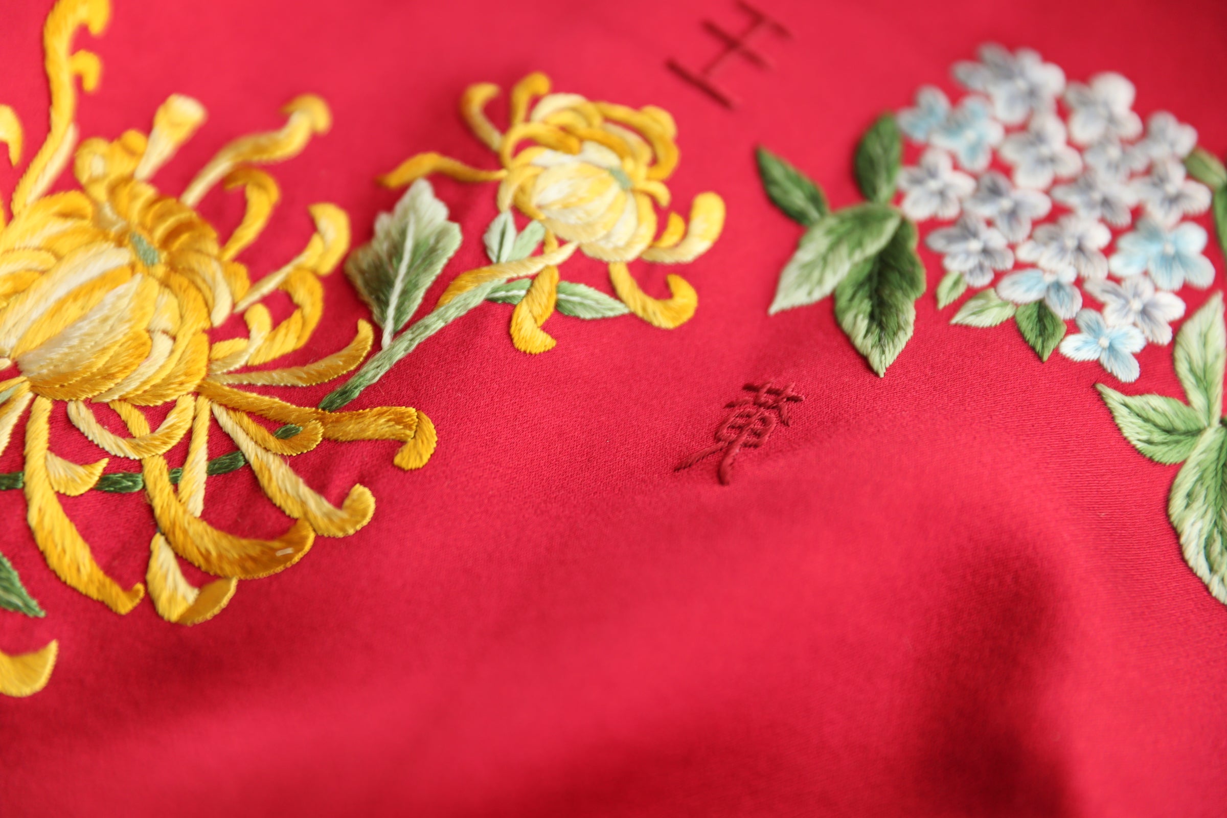 Family Legacy Name with chrysanthemum and hydrangea embroidery on a wedding Qipao