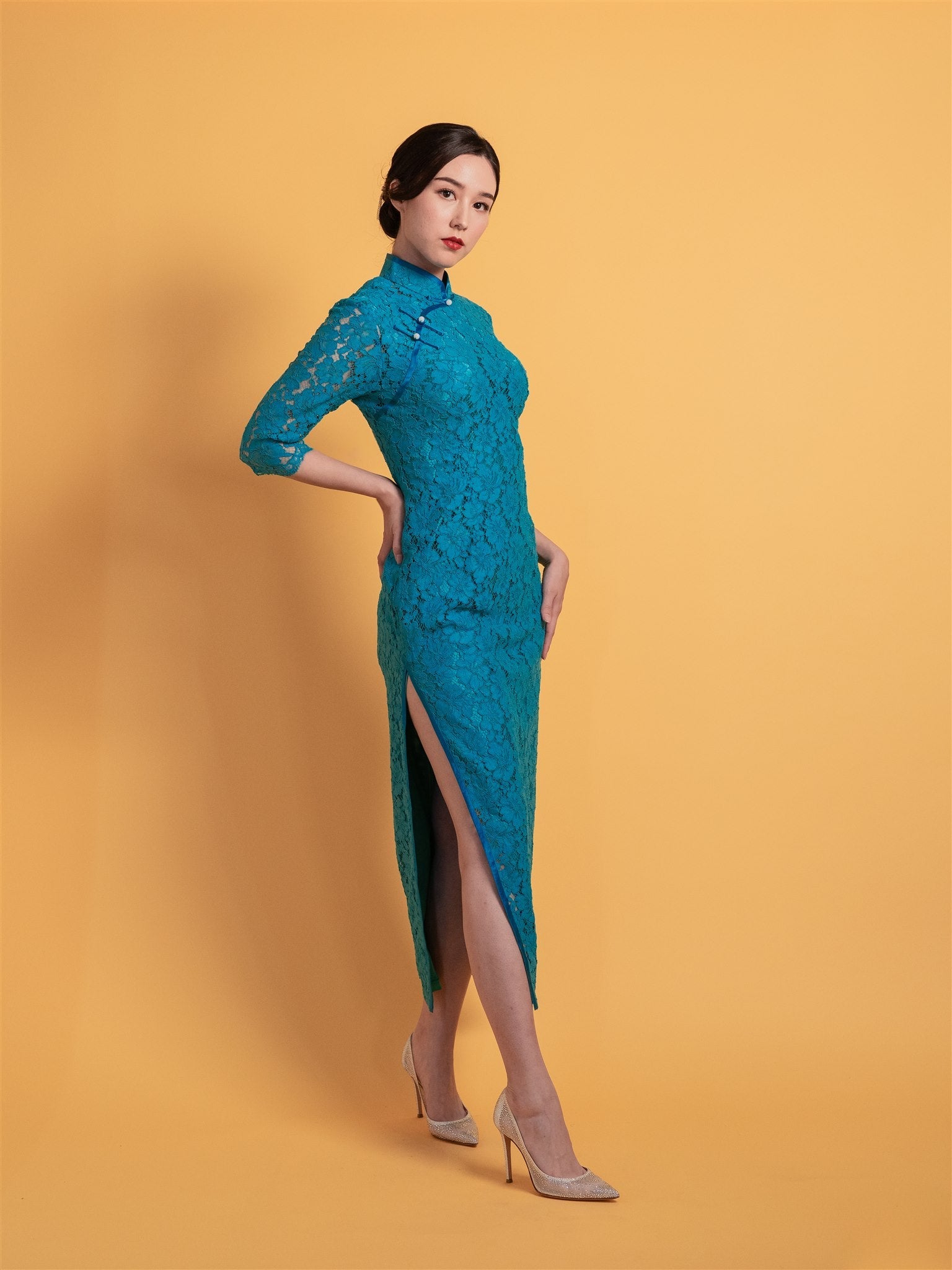 Side view of a teal blue lace Qipao with 3/4 sleeves and full length, designed for mothers seeking stylish and comfortable wear for formal events and weddings. 