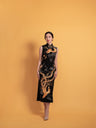 Front view of a classic Qipao dress, with Panjin hand-embroidery dragon & phoenix Qipao dress. A black silk Qipao dress with gold embroidery.
