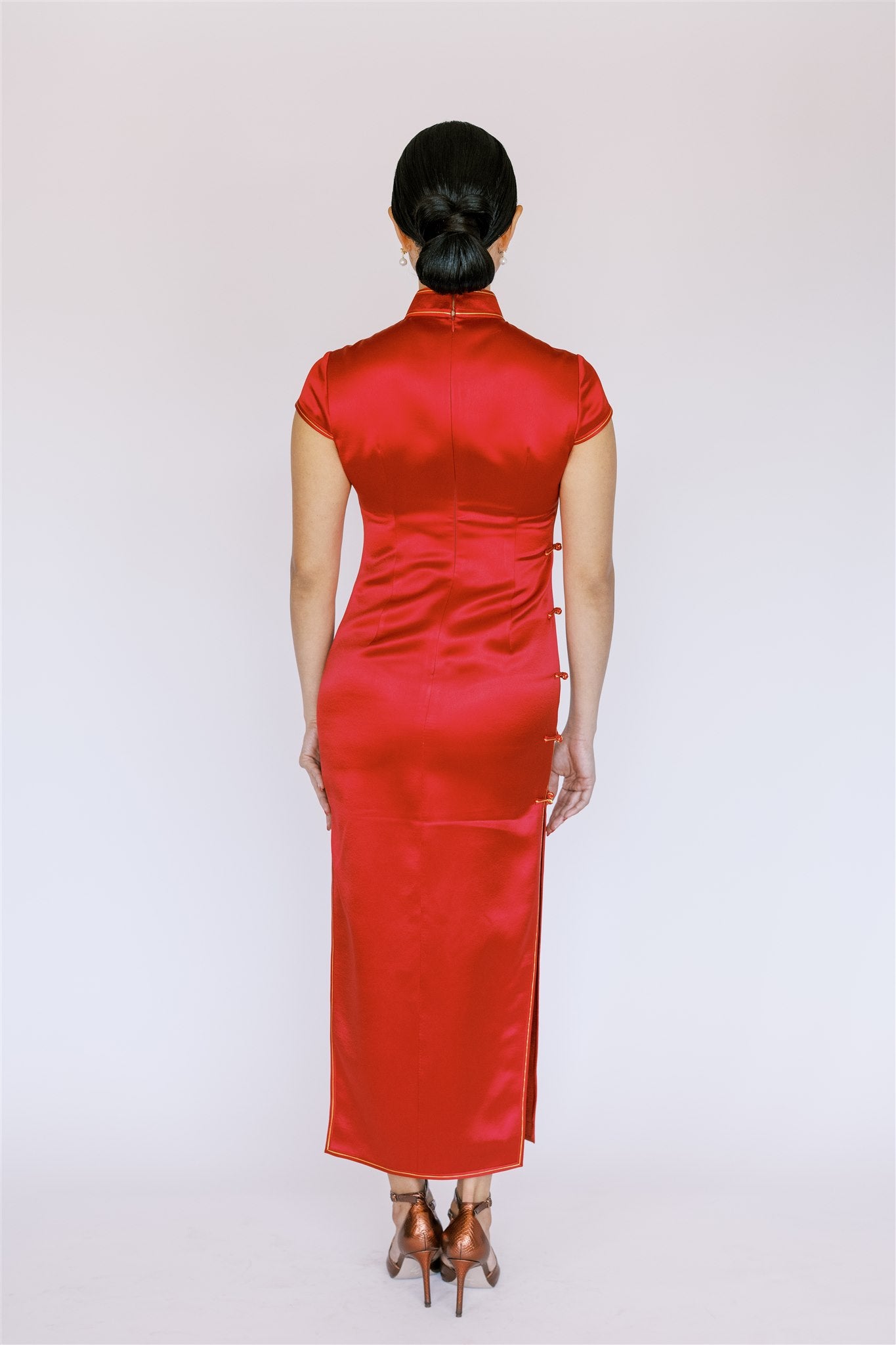 A back view of fine silk fabric on red Qipao, ankle-length. 