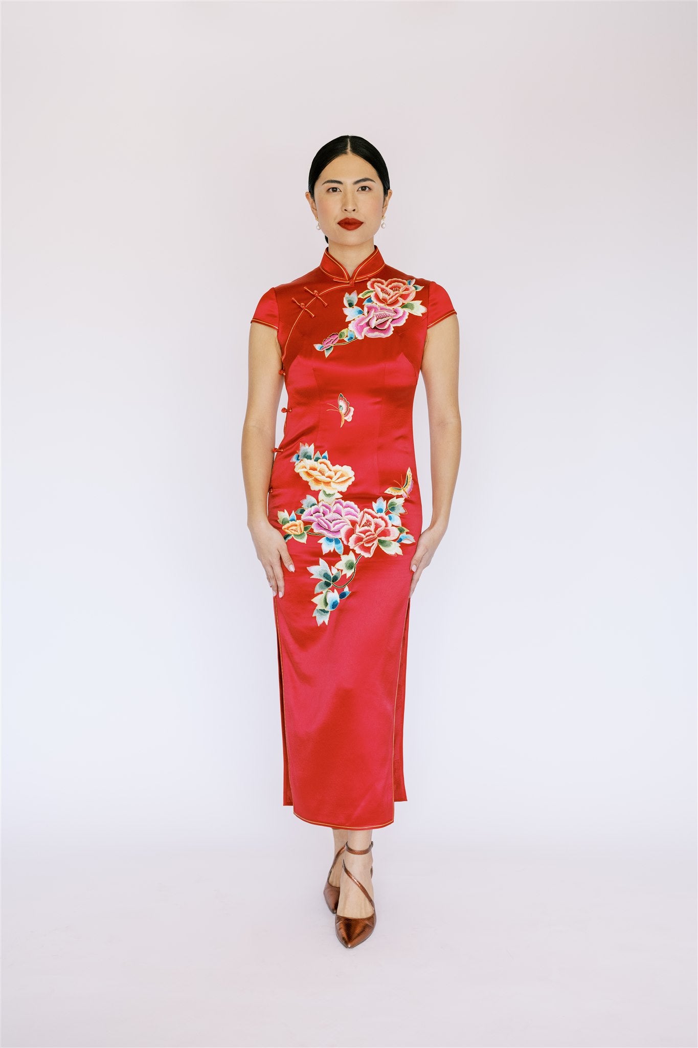 Front view of an elegant eed Cheongsam with peony design. It is a timeless Qipao dress for weddings and formal occasions.