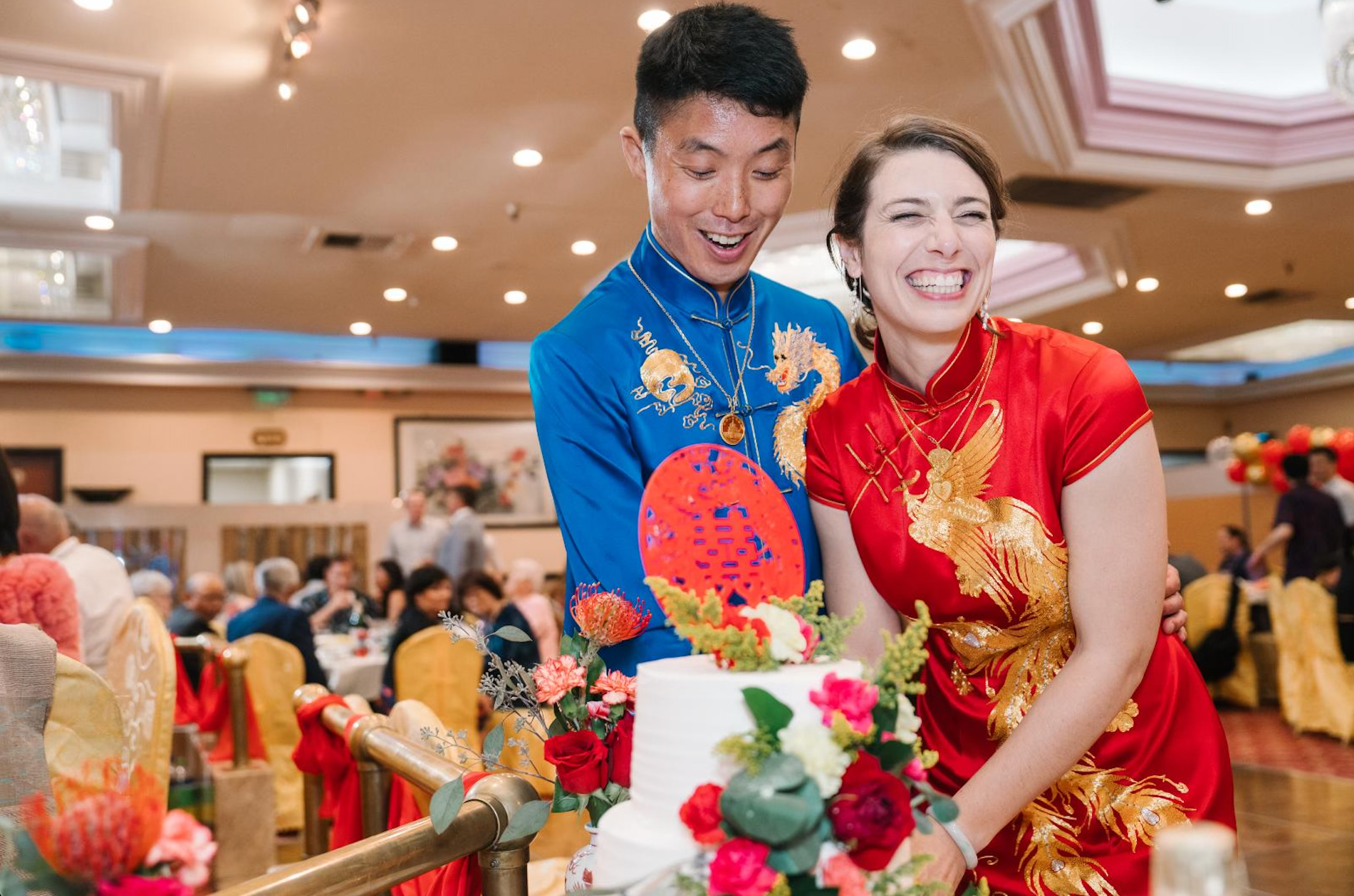 A couple wearing their matching tang suit and wedding Qipao at NBC seafood for their Chinese Tea Ceremony banquet