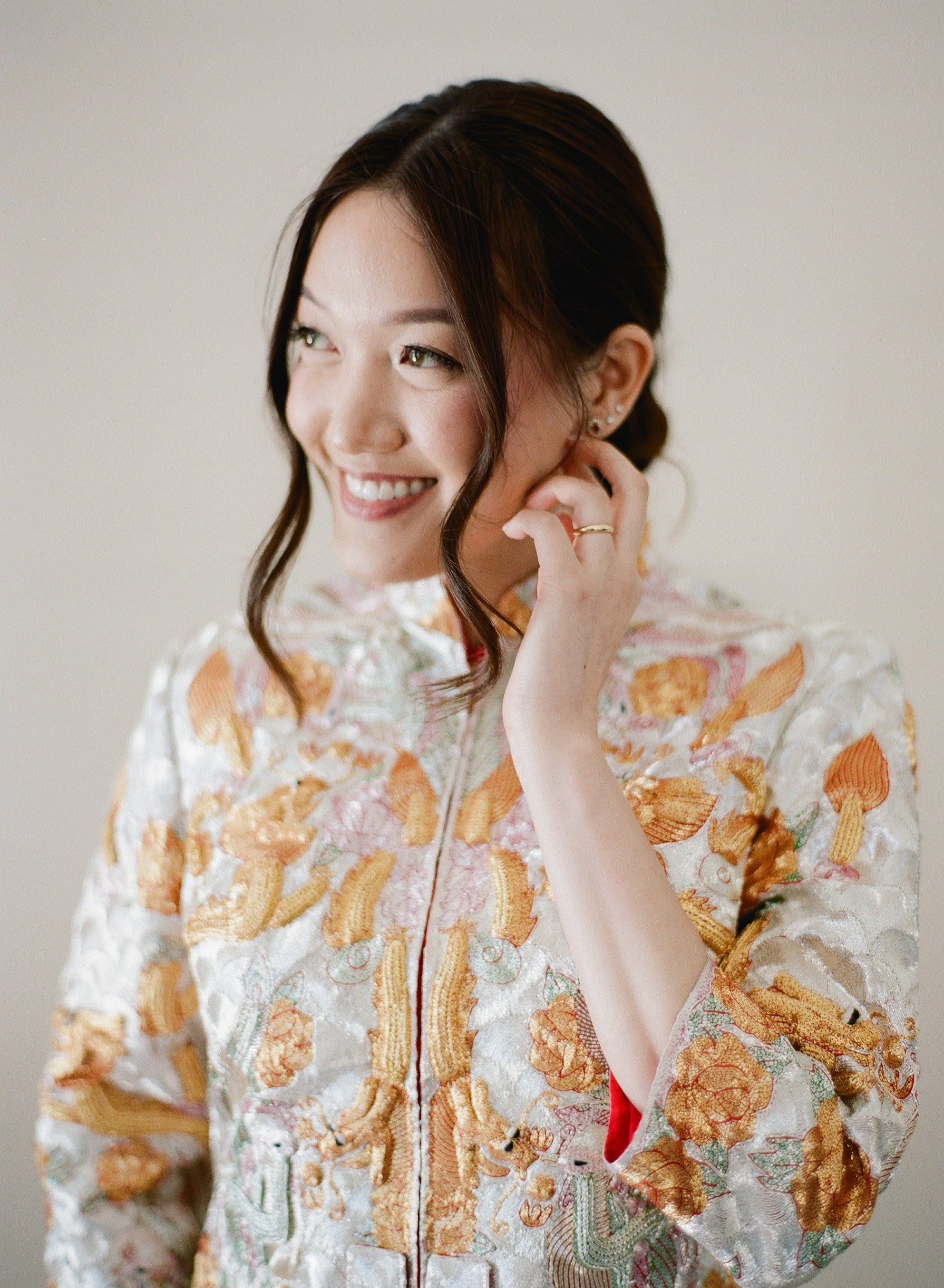 Real client wearing a custom silver silk Qipao with hand embroidery by JINZA