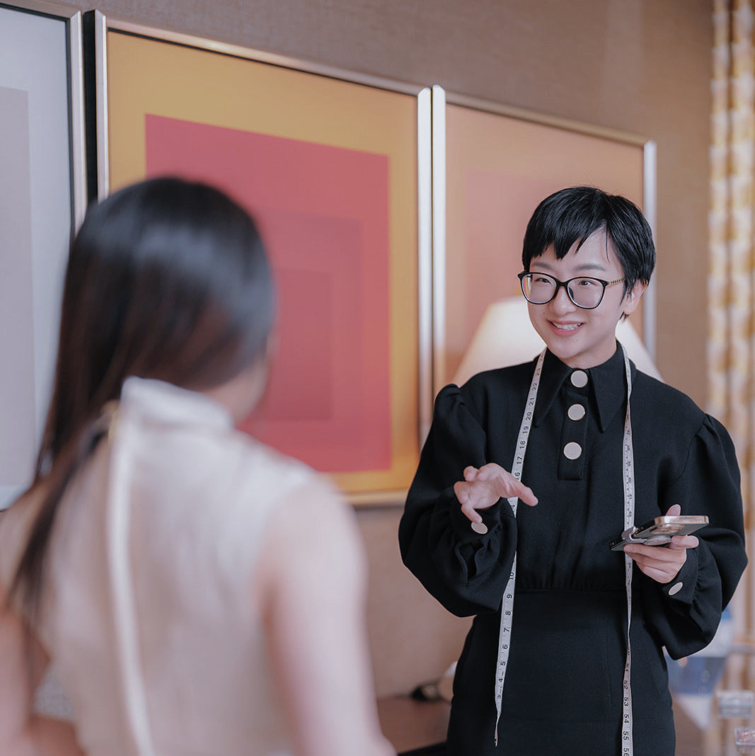 Designer consulting with client on a custom Qipao in Los Angeles studio.
