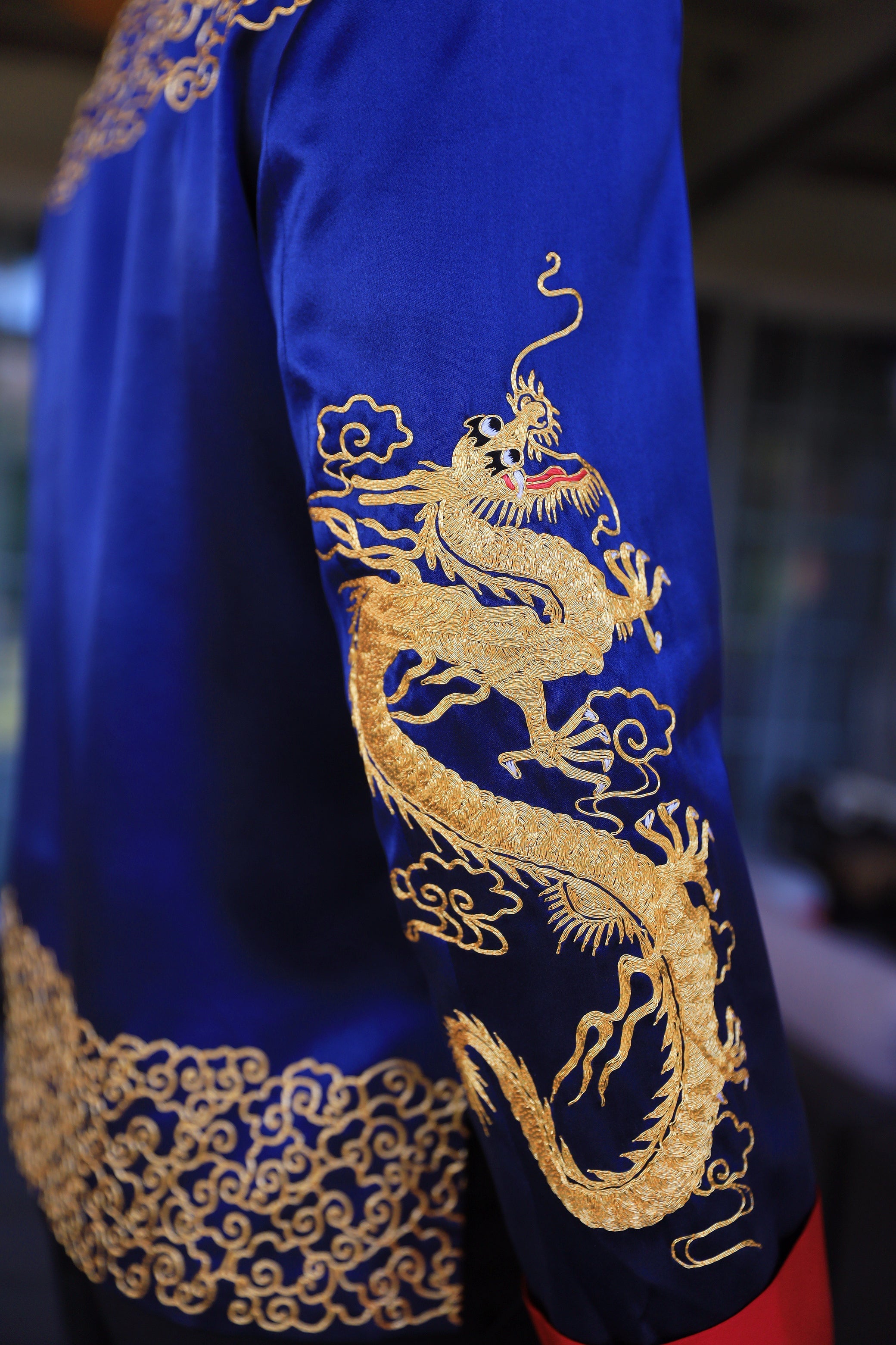 Gold Panjin-embroidered dragon on a royal blue silk tang suit for groom