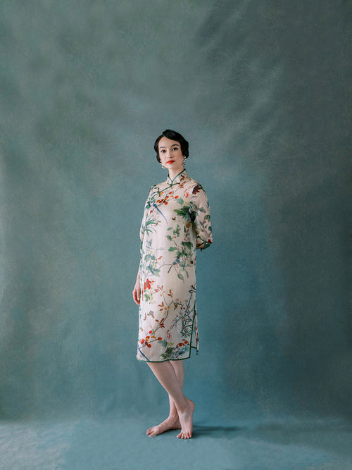 Front view of floral silk organza Qipao dress with bamboo, bird, and flower embroidery.