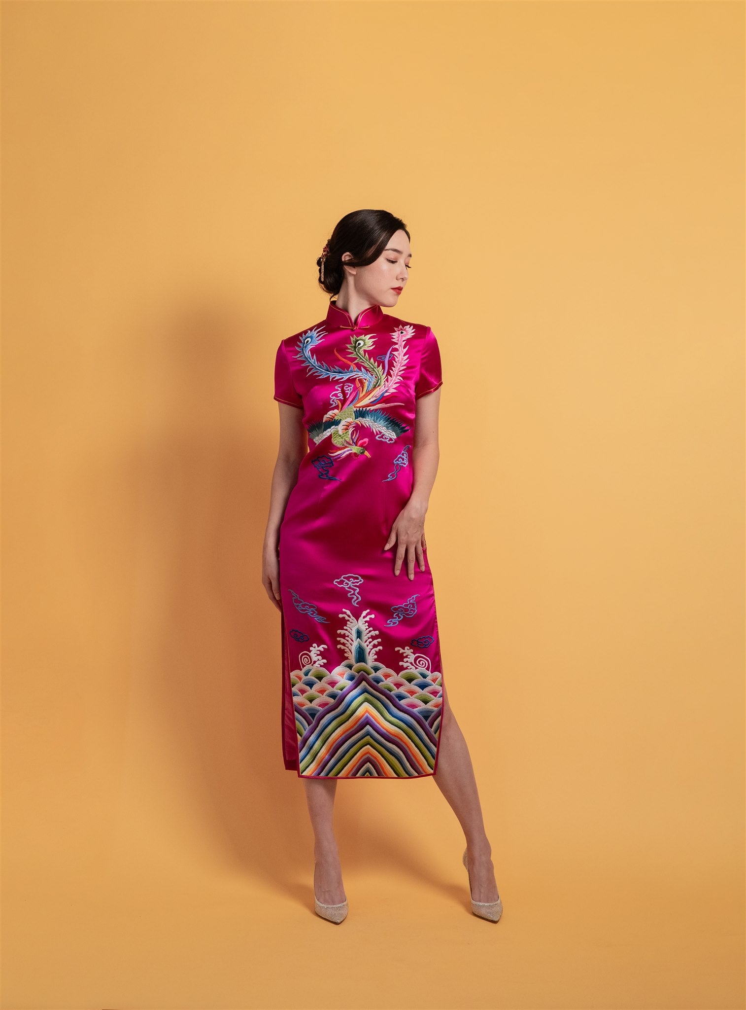 Front view of a fuchsia red Chinese wedding Qipao with colorful Shu embroidered phoenix and rainbow sea waves, mid-calf length by JINZA.