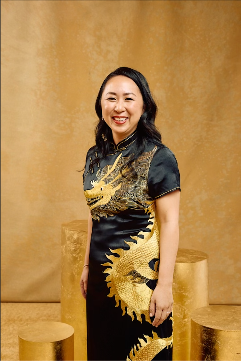 Front view of a black silk Qipao with gold dragon embroidery. It is a full-length Cheongsam for formal occasions.