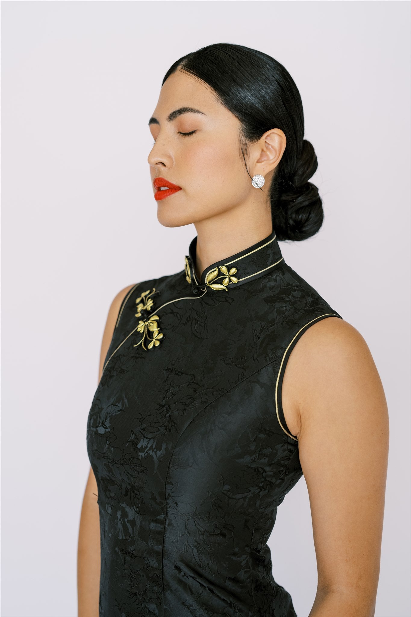 Gold hand-weaven Pankou knot details on a black Qipao