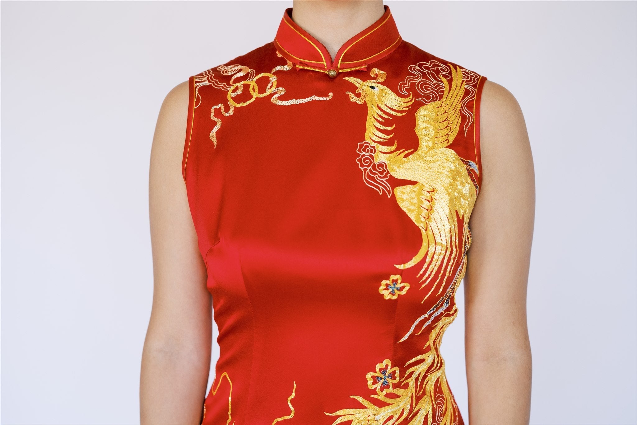 A Panjin-embroidered phoenix on the left chest of a red Wedding Qipao