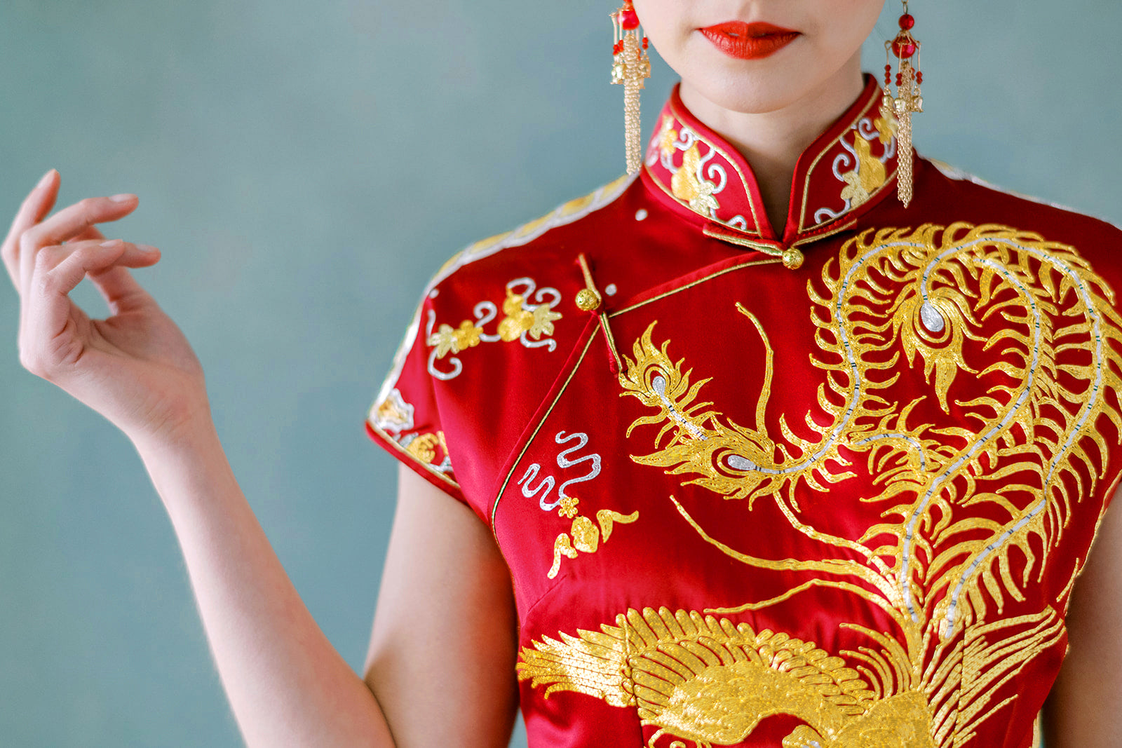 Gold phoenix embroidery detail on wine red Chinese wedding Qipao