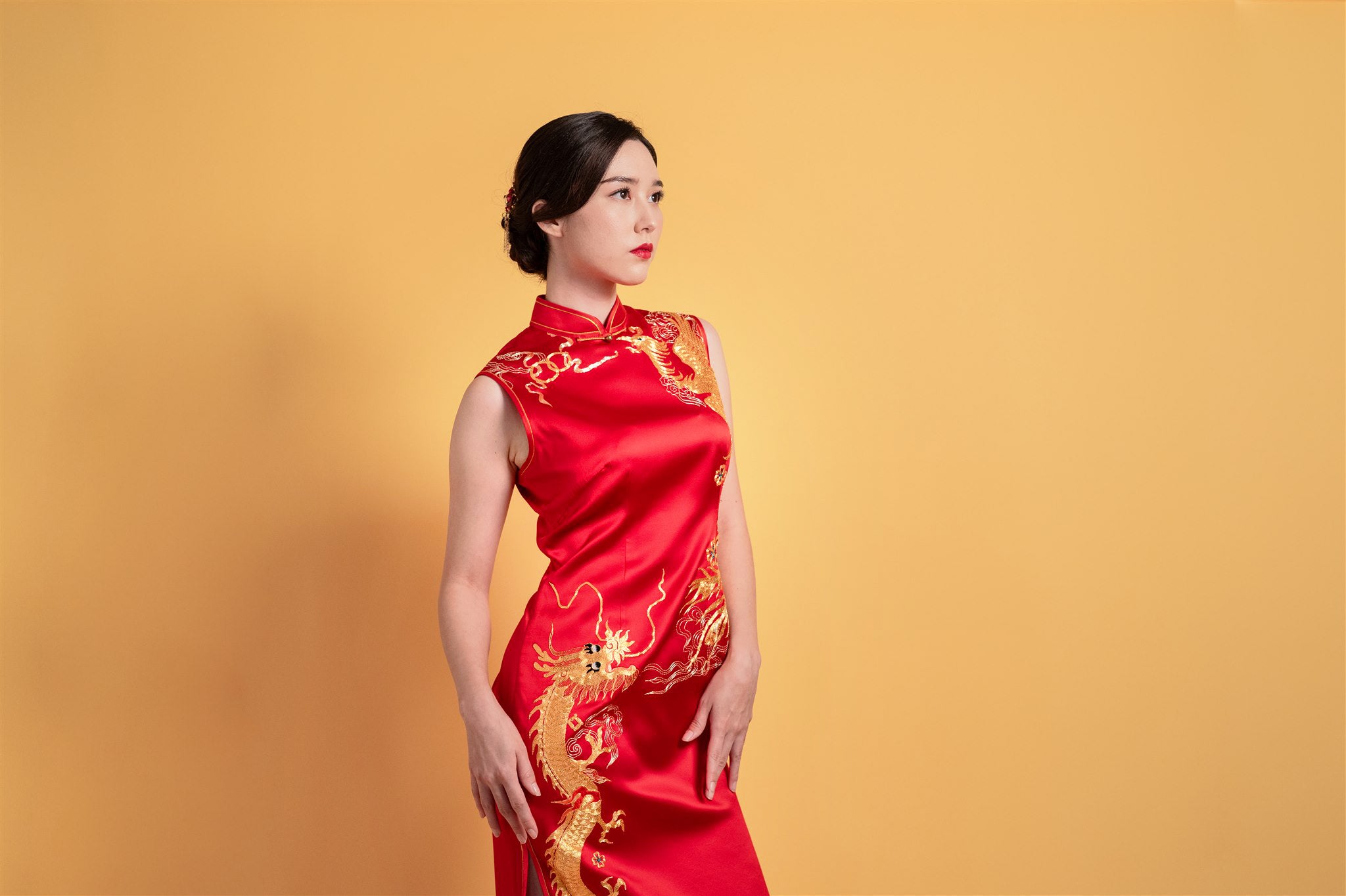 Side view of ankle-length Qipao with gold phoenix embroidery
