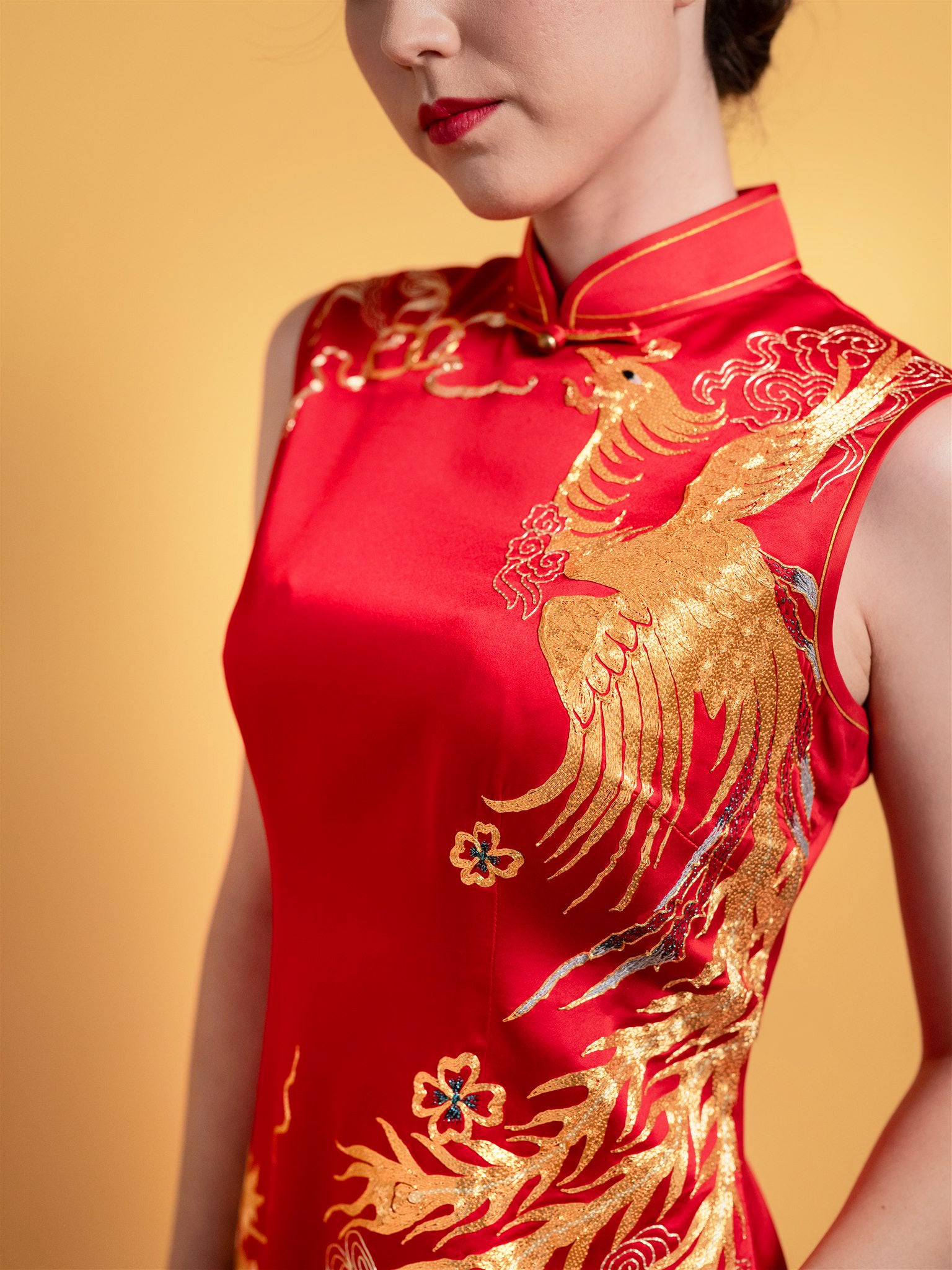 Gold phoenix embroidery detail on red silk Qipao wedding dress

