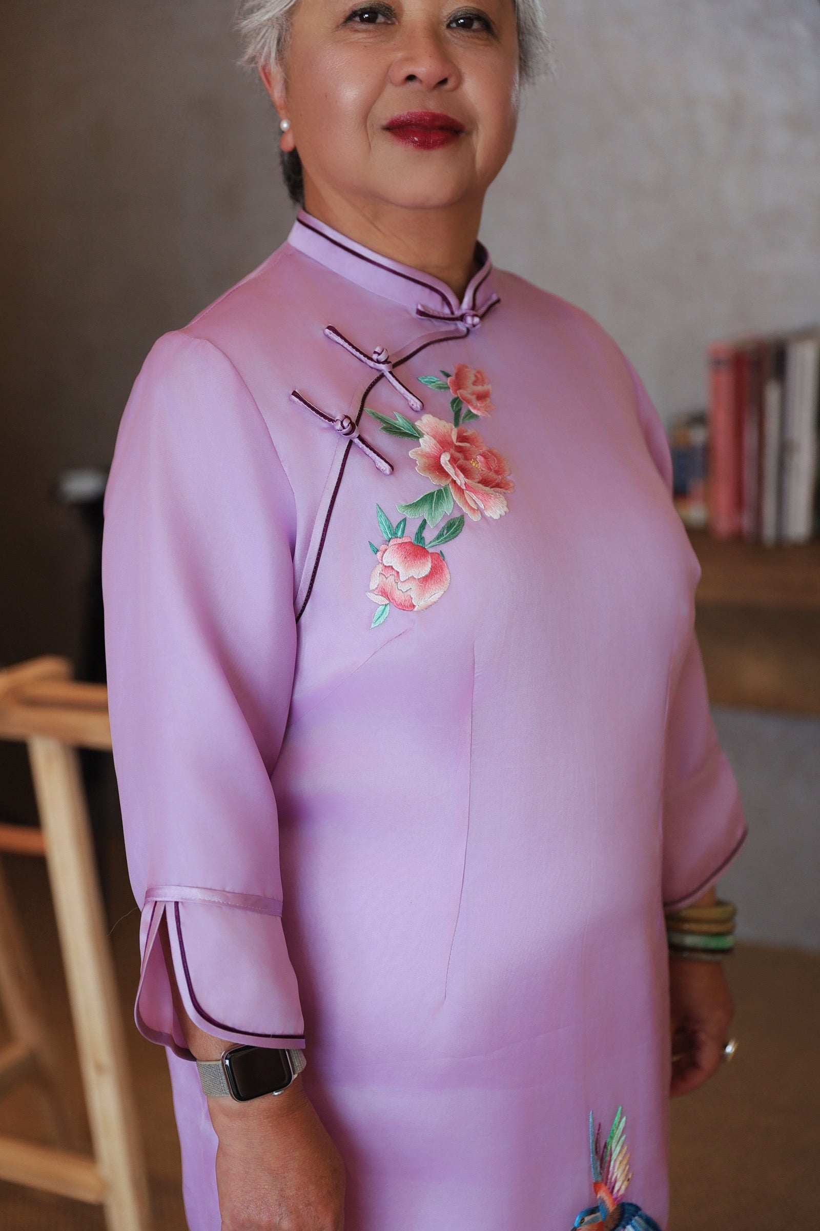 Close-up view of peony embroidery on a lavender silk organza Cheongsam with 3/4 Sleeve and mandarin collar. 