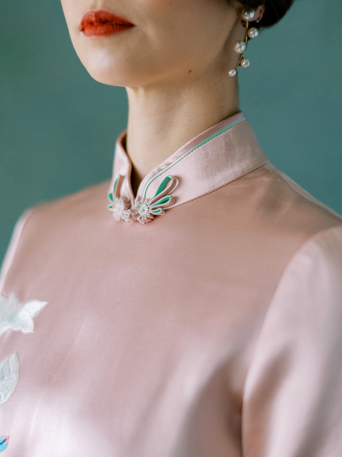 Green silk trim and floral Pankou knots on ¾ sleeve blush Qipao