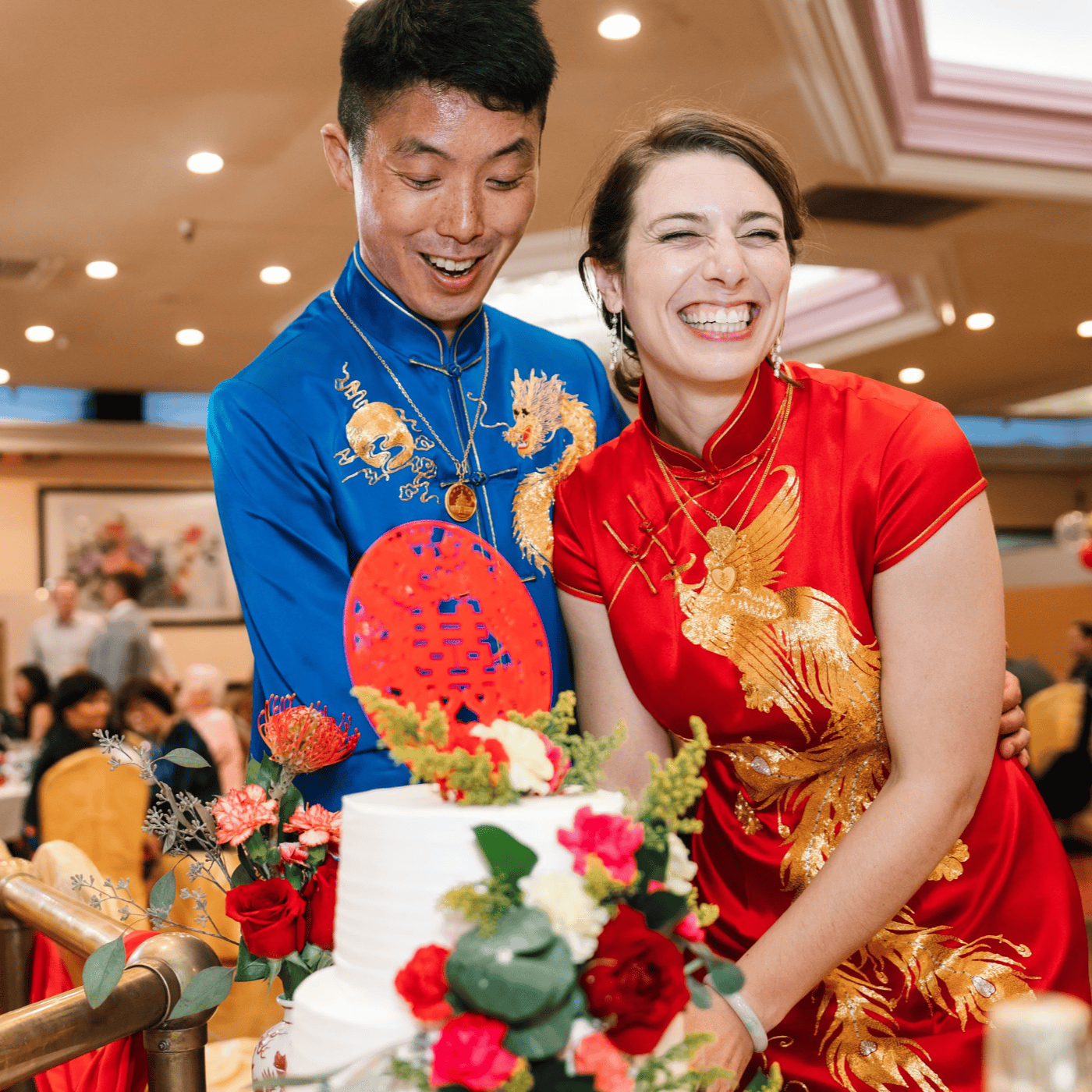 Bride Leslie in bespoke red Qipao and groom Kevin in blue Tang suit at Chinese tea ceremony, custom made to measure at JINZA Los Angeles