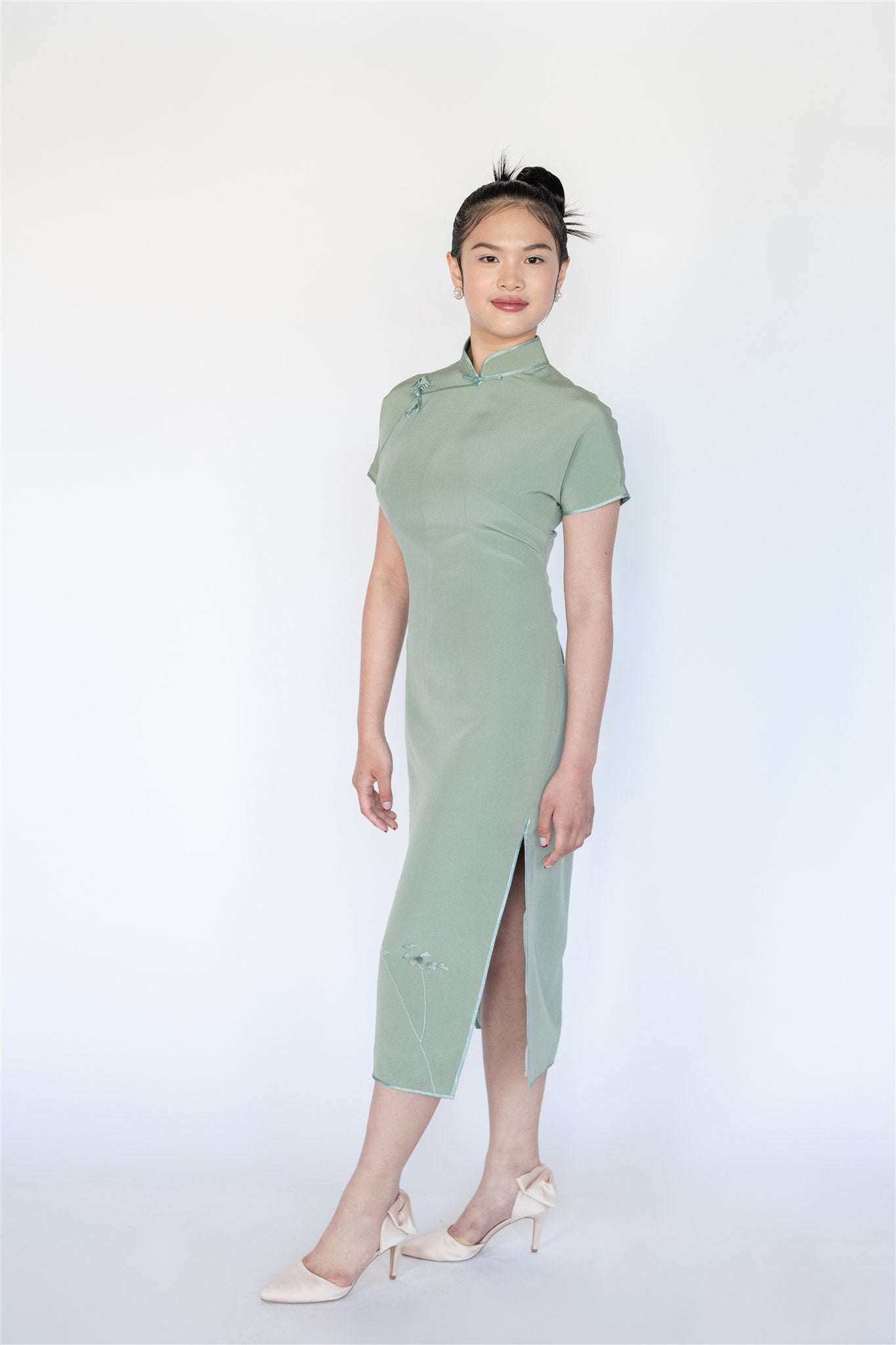 Side profile of green minimalist cheongsam made from Japanese silk