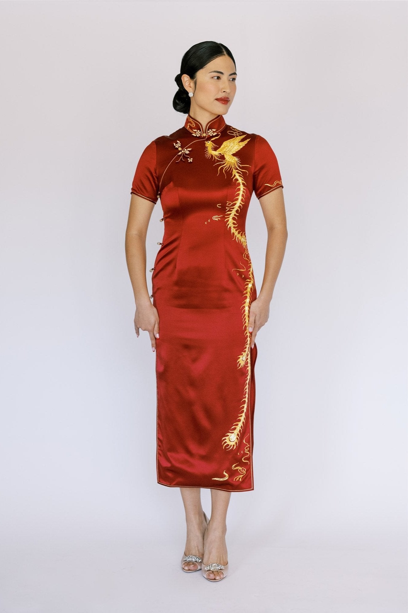 A woman wearing a wine red traditional cheongsam