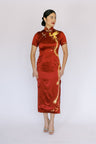 A woman wearing a wine red traditional cheongsam