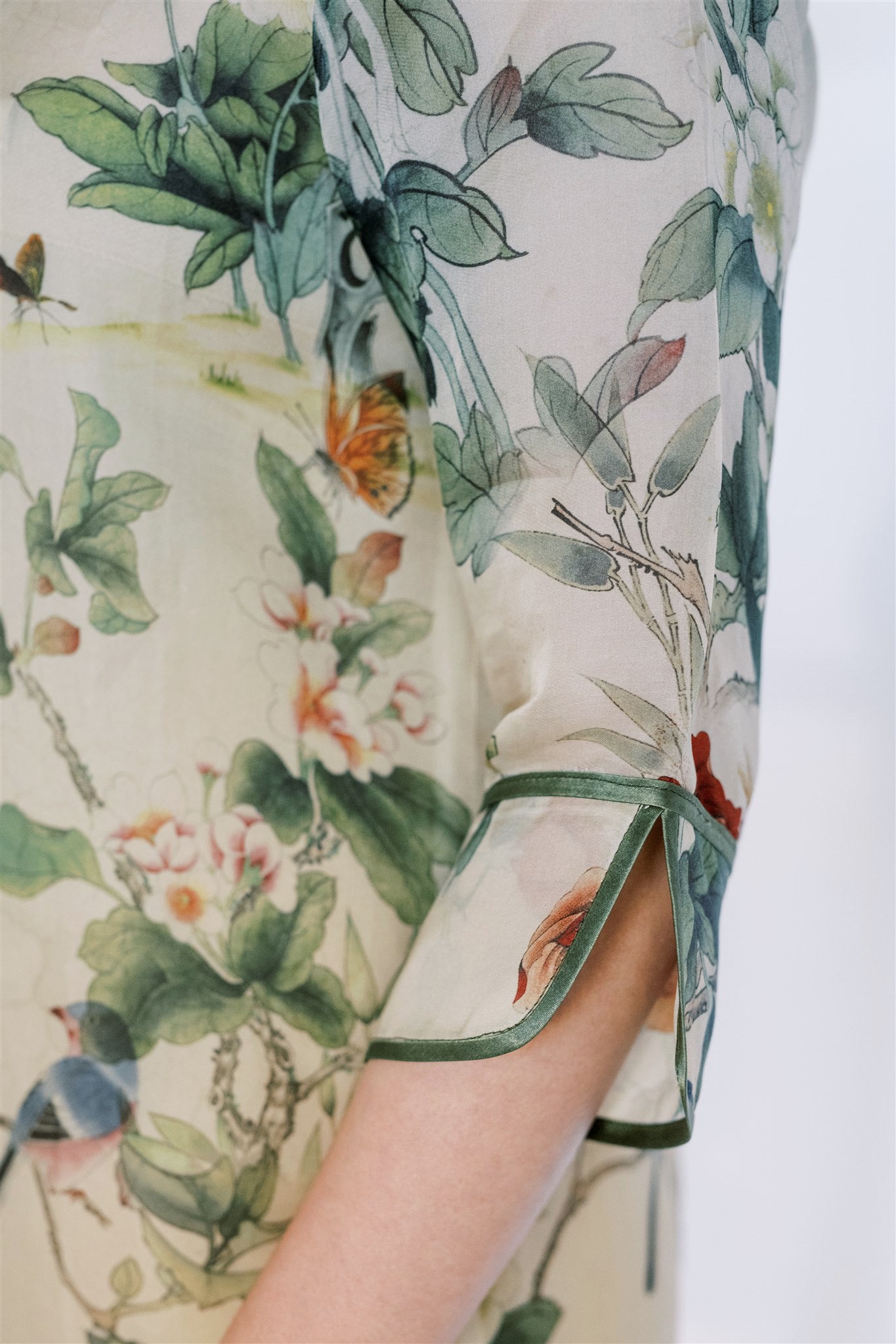 Close-up of details on the 3/4 sleeves on mother's silk Cheongsam, a high-quality, breathable Qipao with hand details.