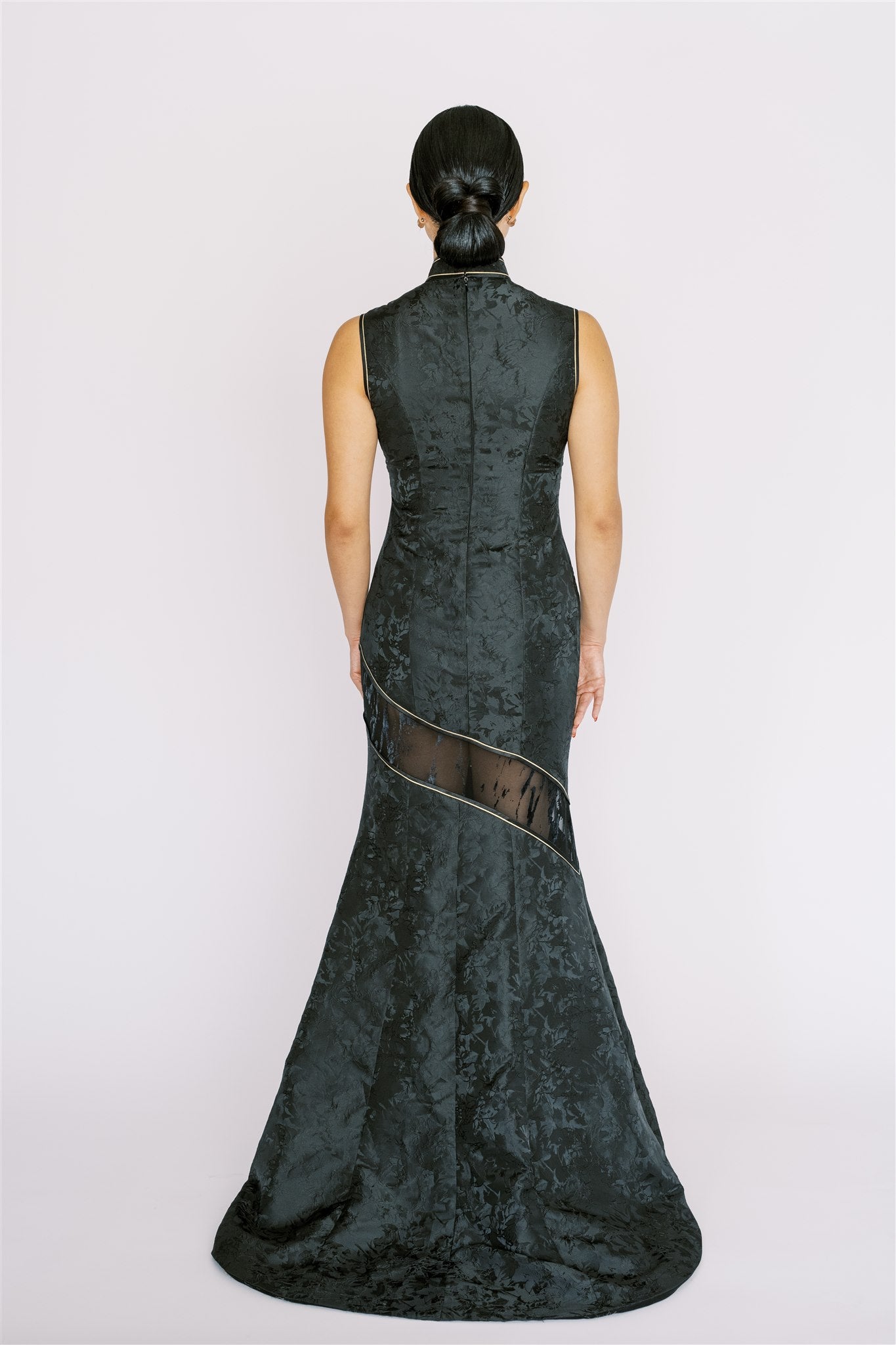 Back view of long train detail on black Cheongsam, along with the lace cut and fitted design. 