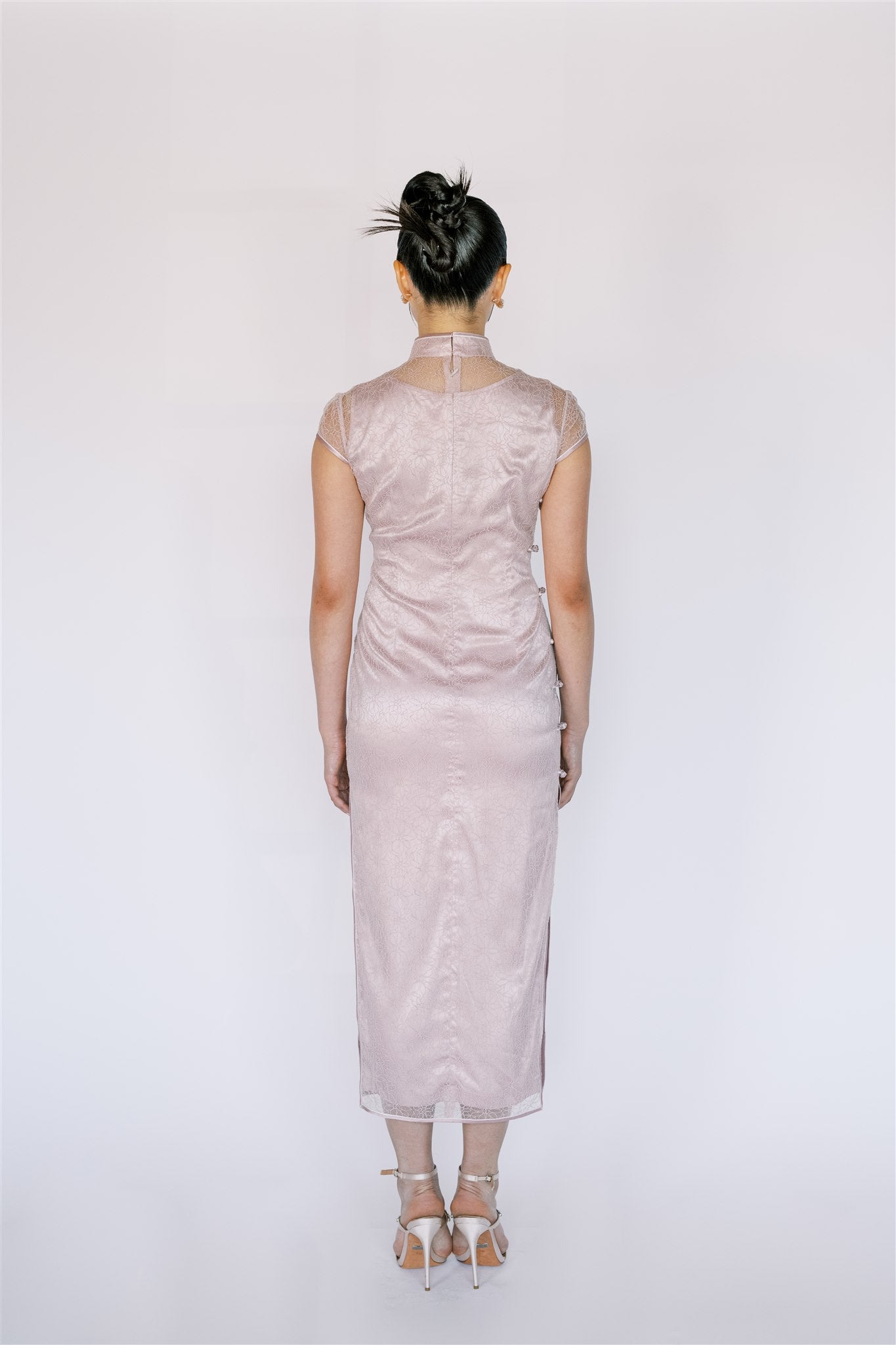 Back details of modern Qipao with feminine lace design and mid-calf length.