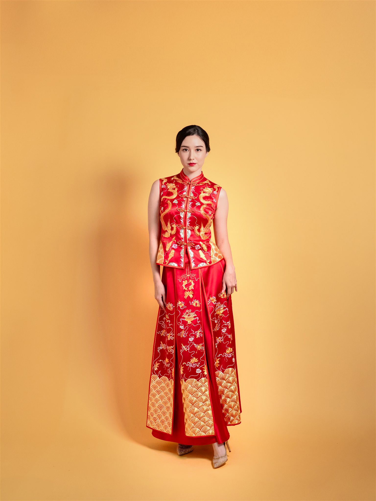 Front view of modern Dragon and Phoenix Xiu He Fu Chinese wedding dress with gold embroidery.