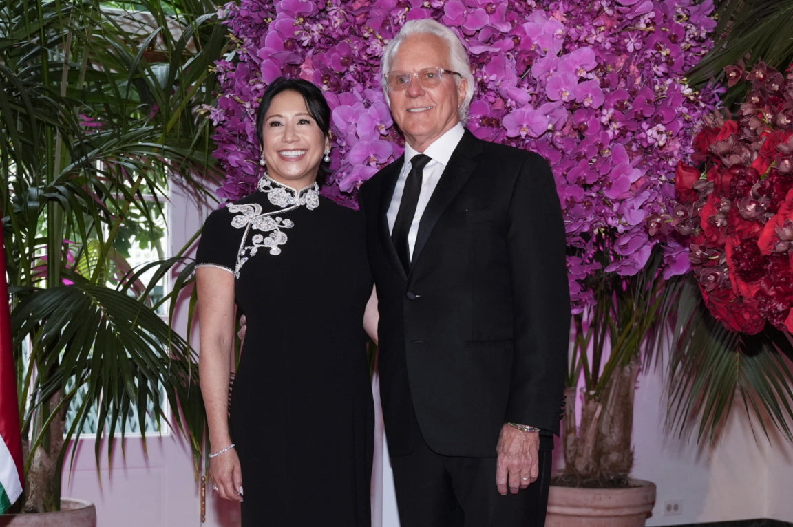 A couple wearing black luxury cheongsam with cap sleeves and indian embroidery