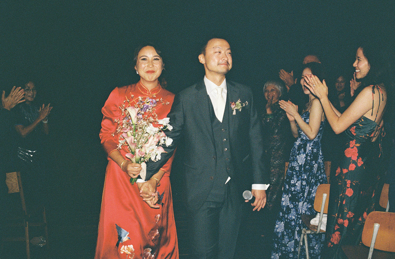 A bride wearing her modern Ao Dai wedding dress at her reception.