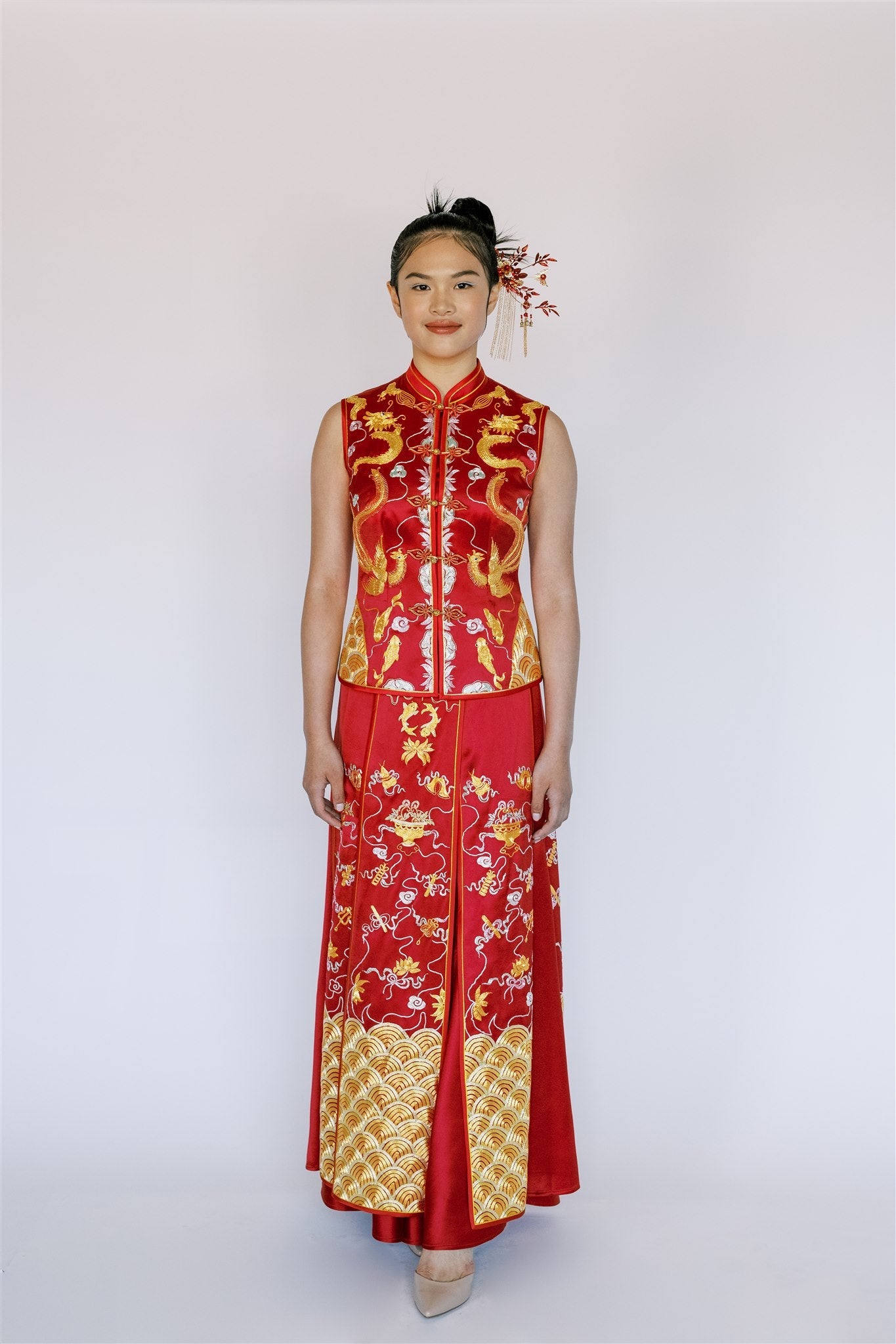 A girl wearing a modern sleeveless Xiu He Fu with dragon and phoenix embroidery