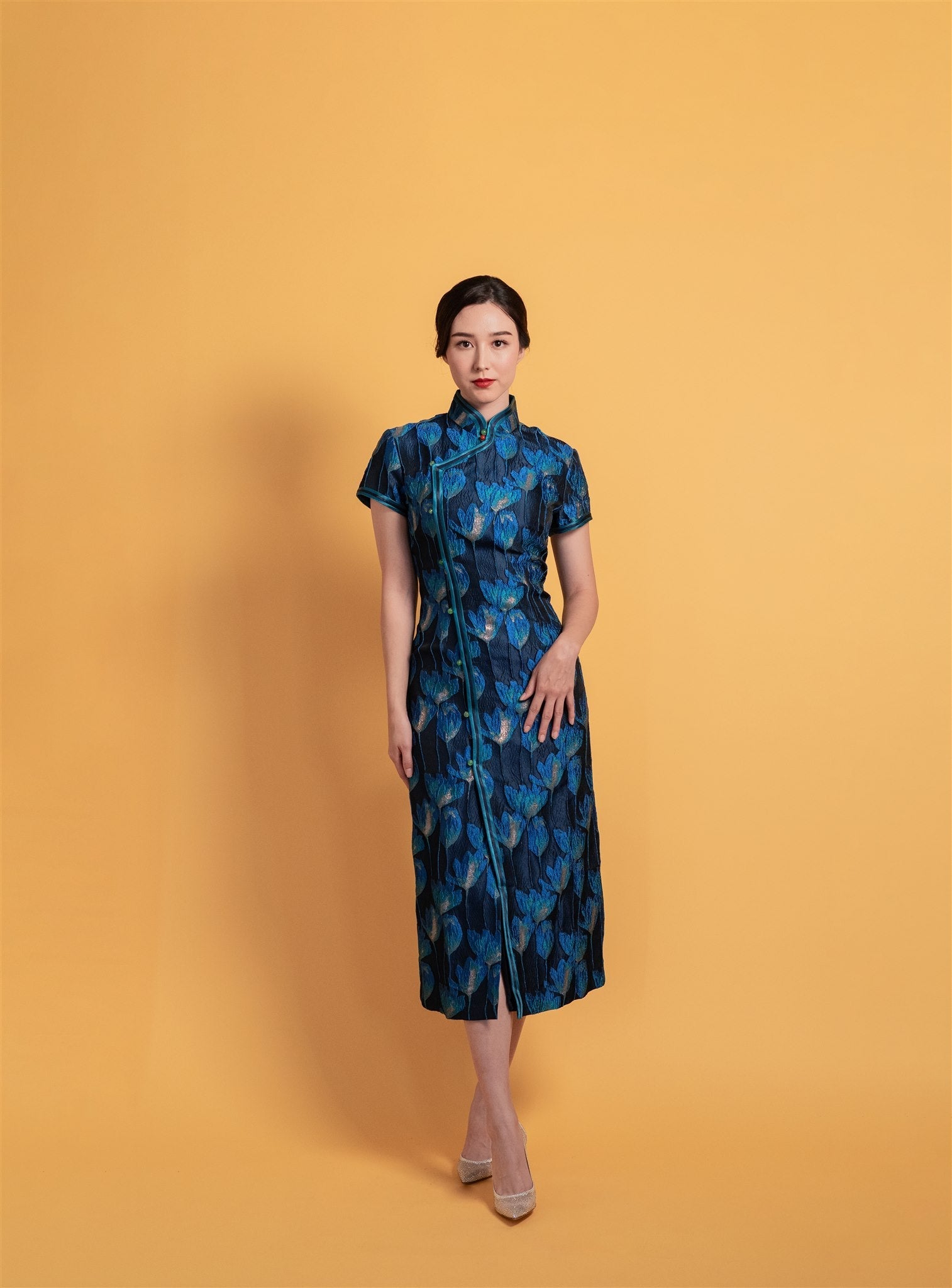 Front view of a navy blue tulip patterned cotton Cheongsam with an A-line silhouette, cap sleeves, and side closure with green buttons, ideal for mothers or everyday wear.