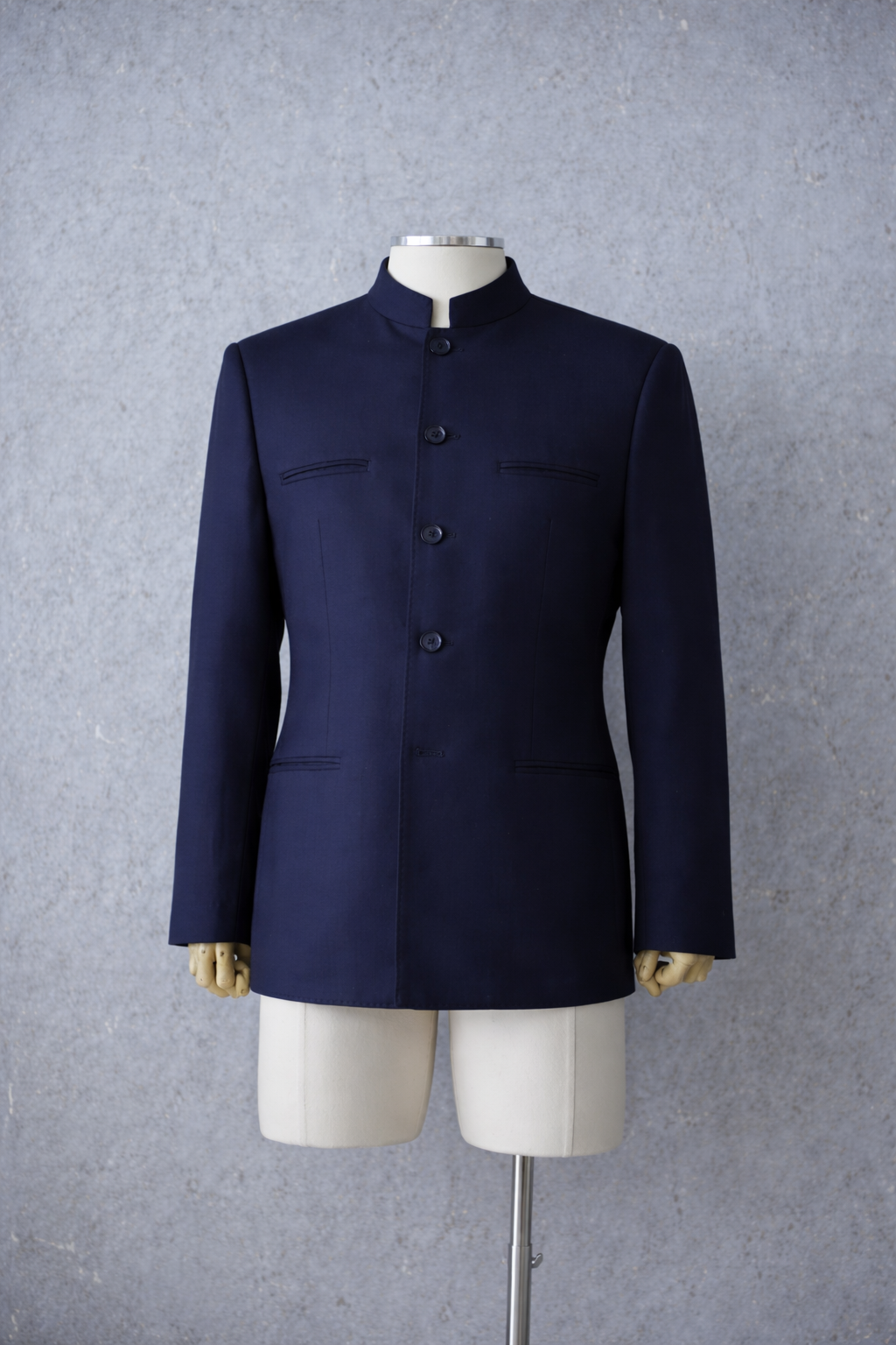 Navy blue Zhongshan suit in Italian wool with structured Mandarin collar and tailored silhouette.